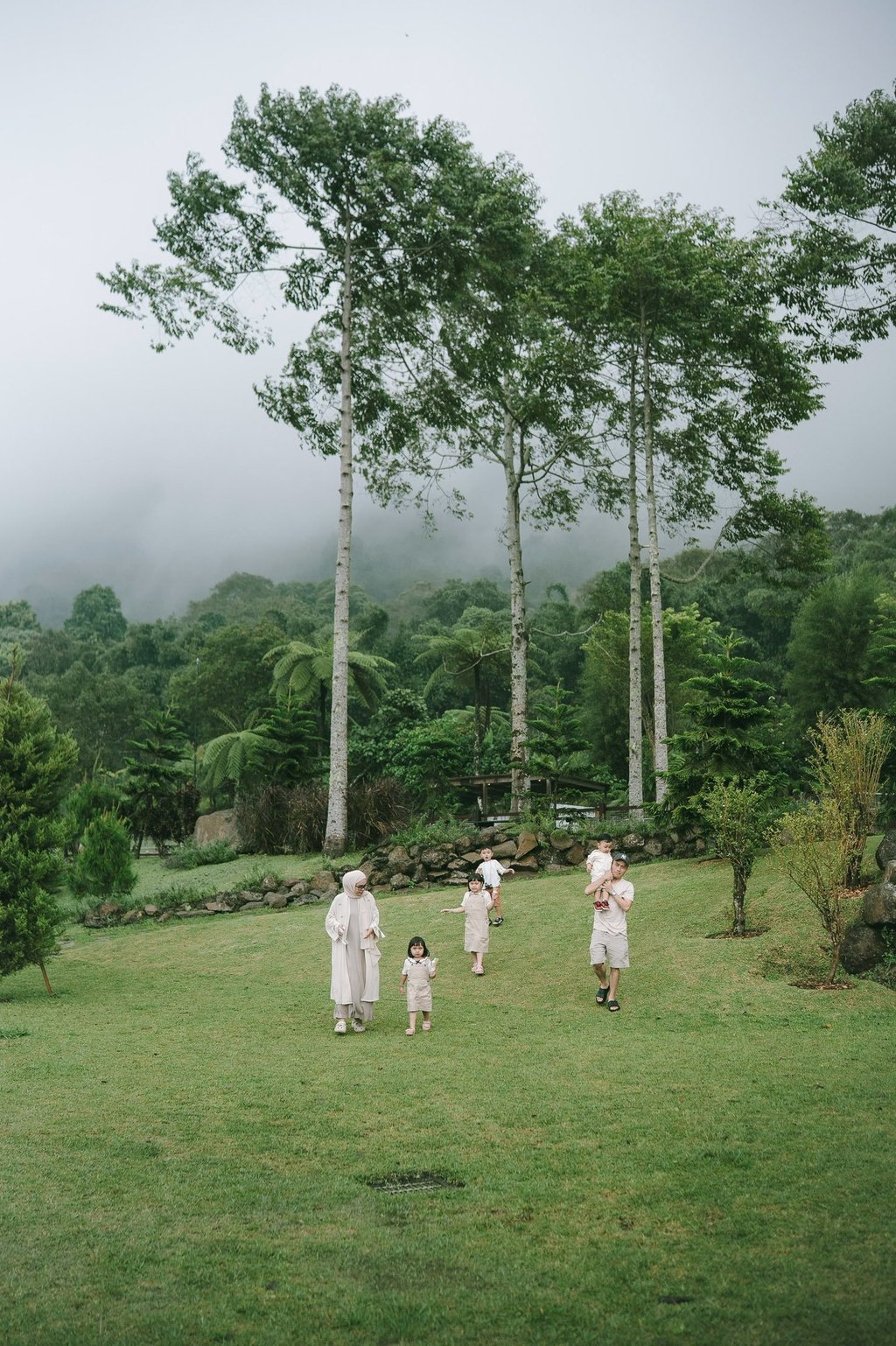 Children playing in open field during a family photography session at Bali Farm House Bedugul Bali.