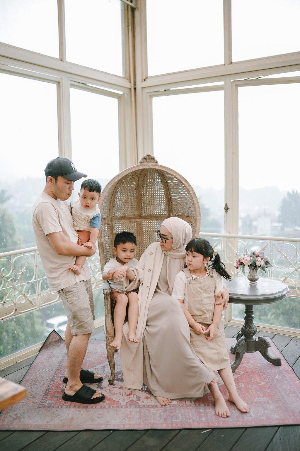 Family portrait inside glass house during a family photography session at Rumah Gemuk Bedugul Bali.