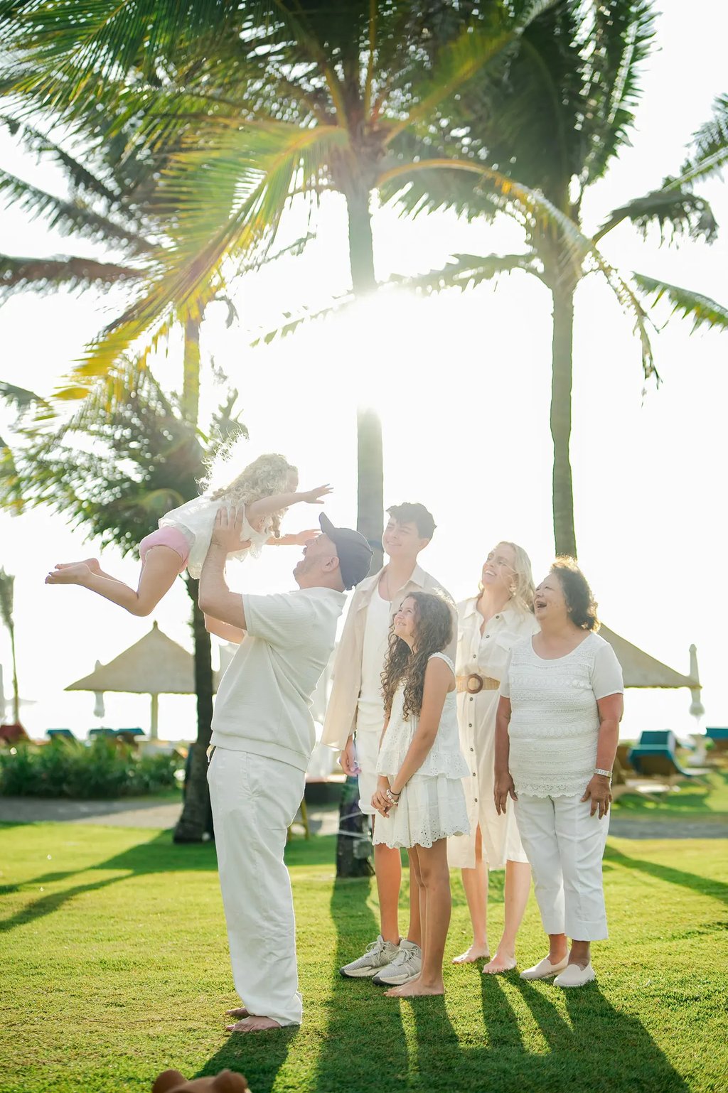 Family portrait captured during golden hour in the tropical gardens of Ayodya Resort Bali