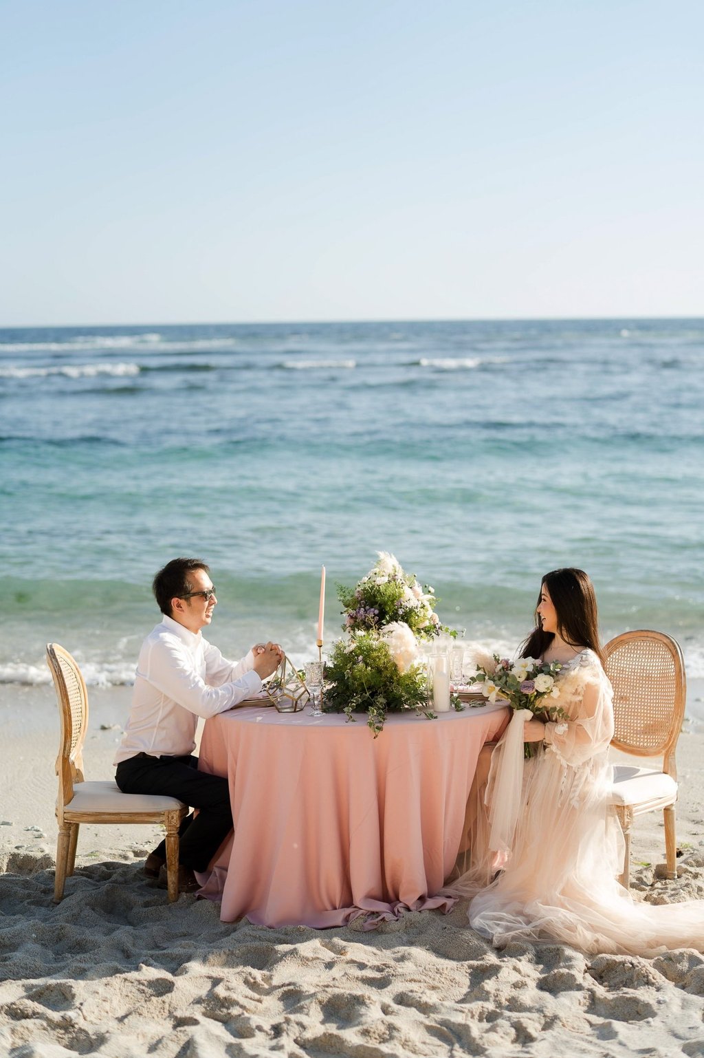 Luxury prewedding couple romantic beach dining at Melasti Beach Ungasan Bali