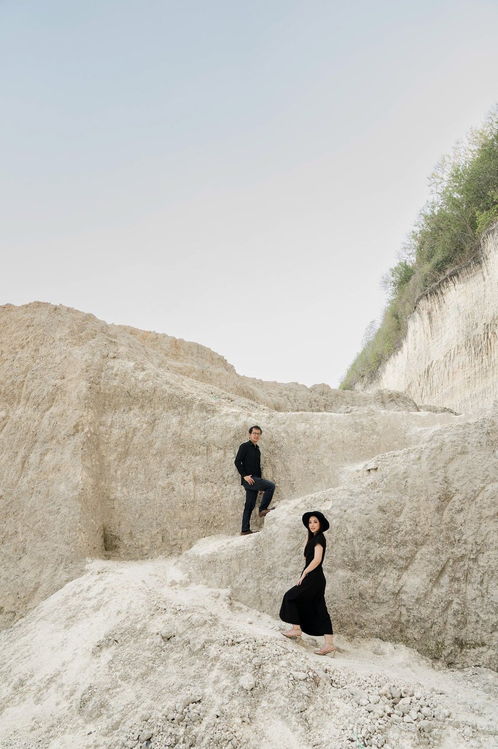 Dramatic prewedding portrait at limestone cliff of Melasti Beach Bali
