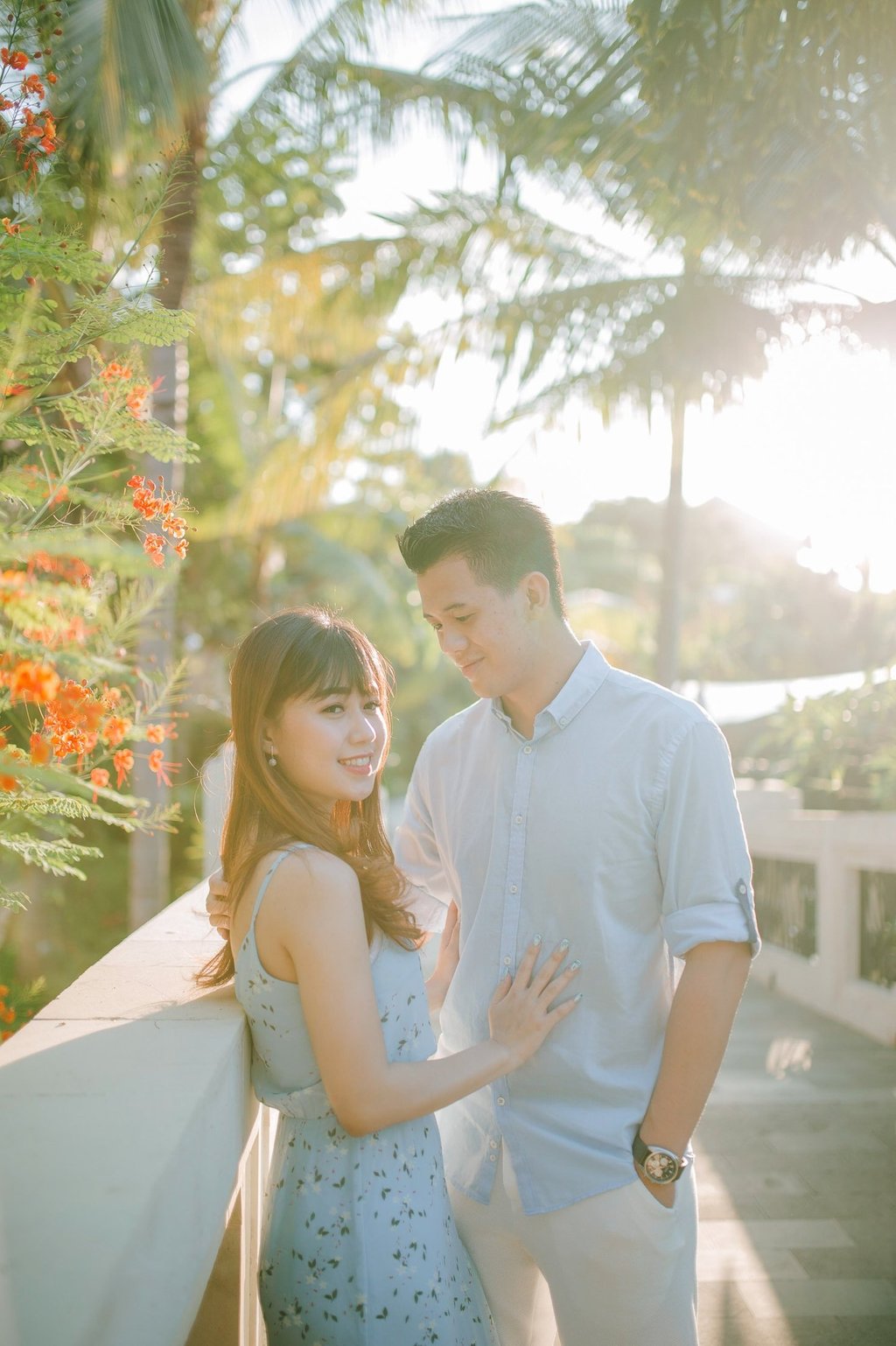 Intimate couple portrait on balcony at Sofitel Bali Nusa Dua Beach Resort during sunset.