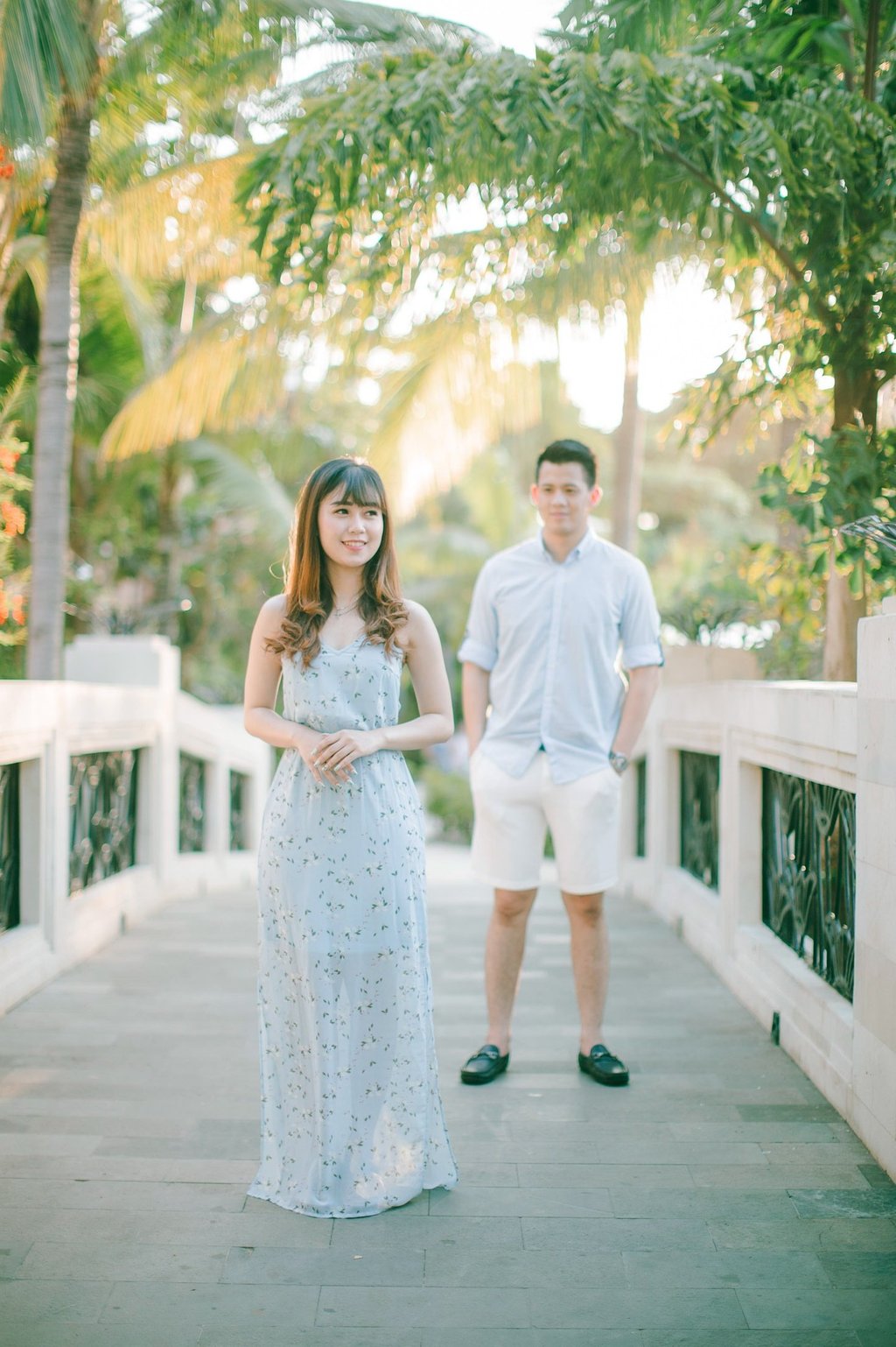 Full body intimate couple portrait on bridge at Sofitel Bali Nusa Dua Beach Resort.