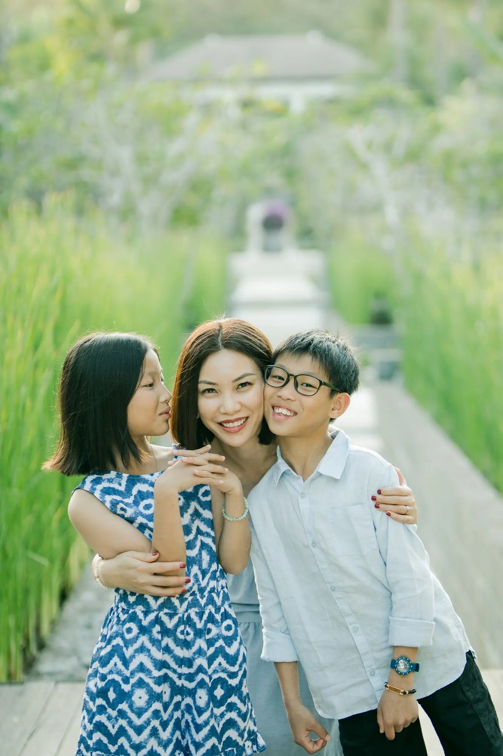 Brother and sister sharing a playful moment during a family photography session at The Ritz-Carlton Bali.