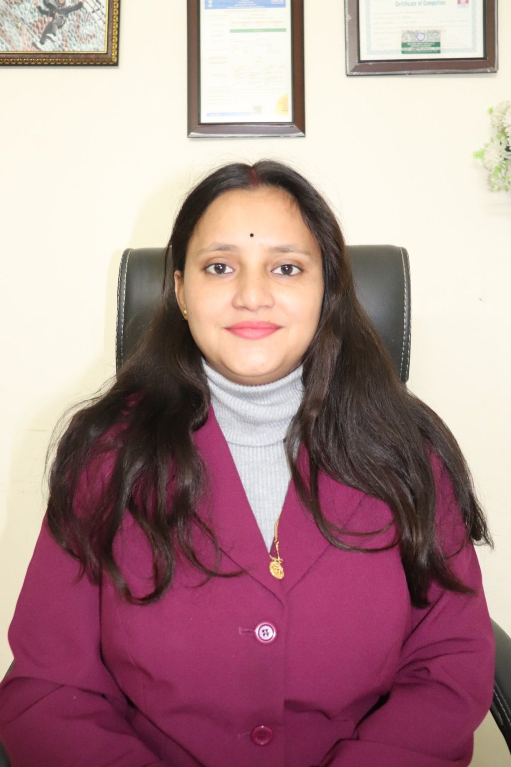 a woman in a purple jacket and a white shirt