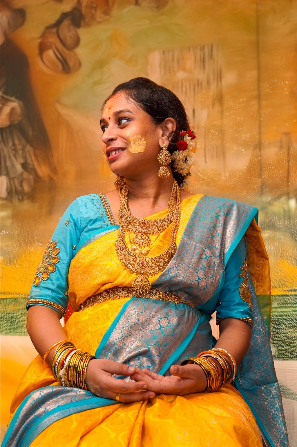 A bride in a blue and yellow silk saree during a pre-wedding photoshoot by Memories and More Photogr