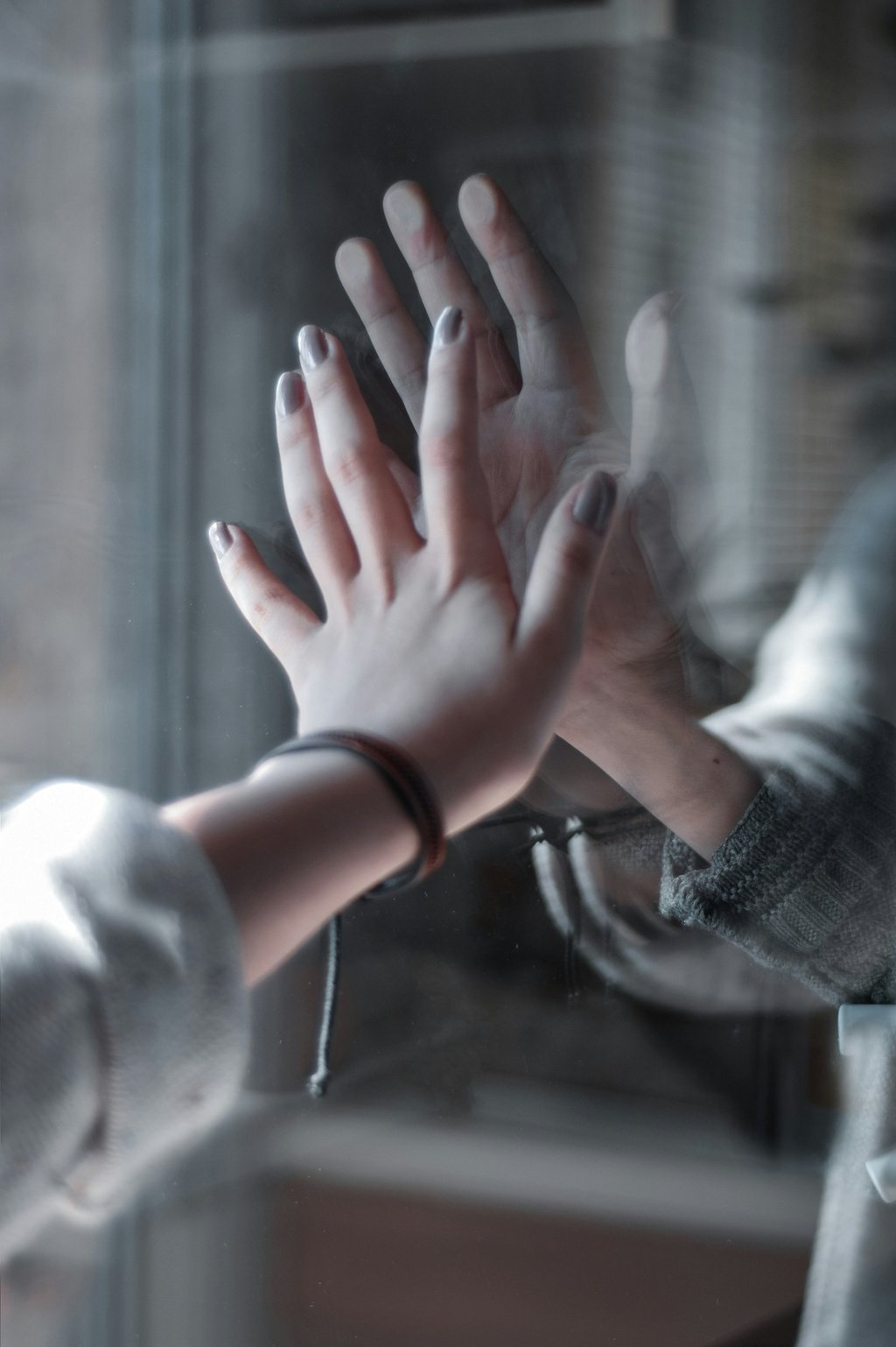 a person holding their hands up to a person's hand