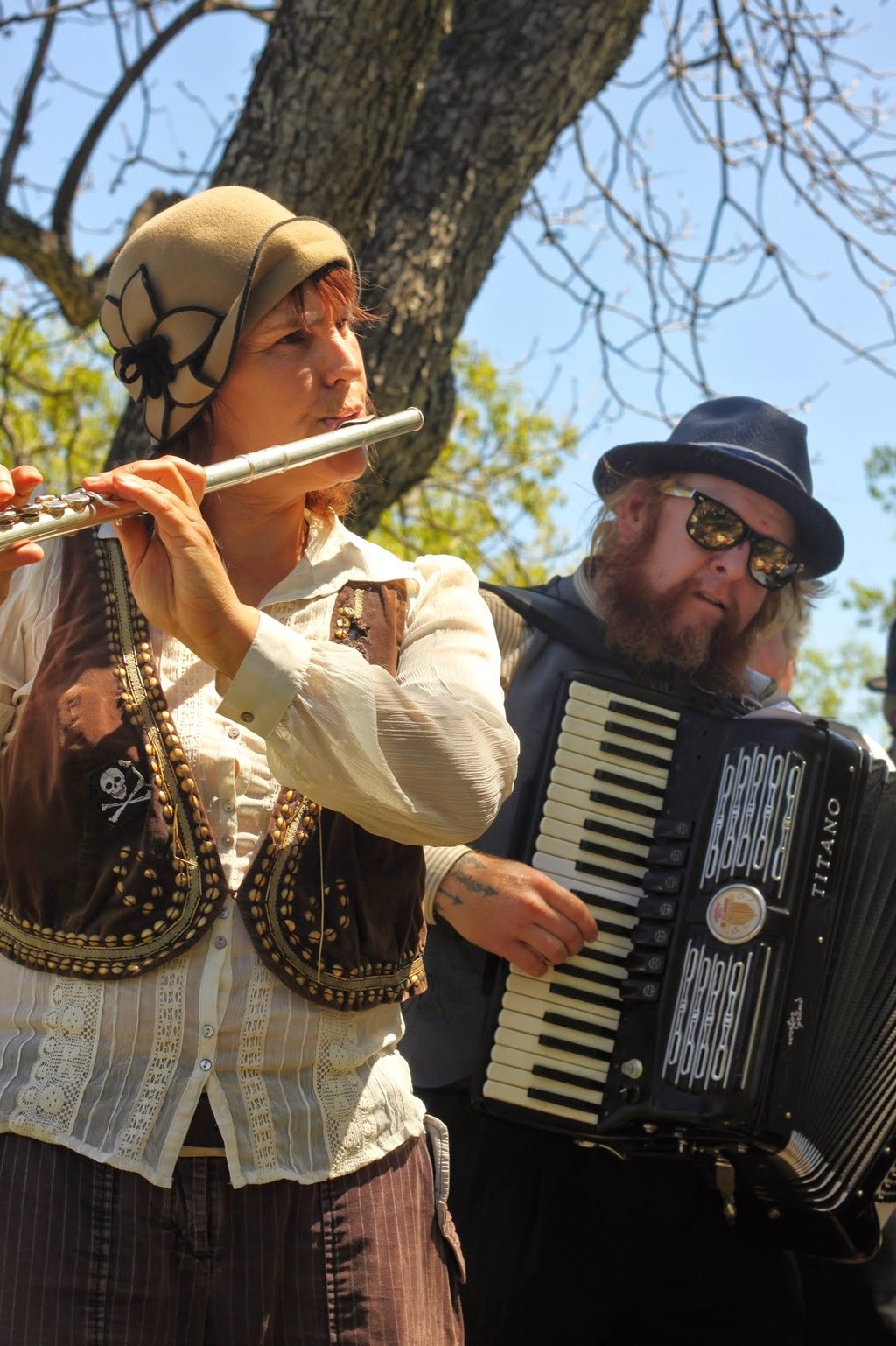 Mazel Tov Kocktail Hour founders playing flute and accordion at a show.