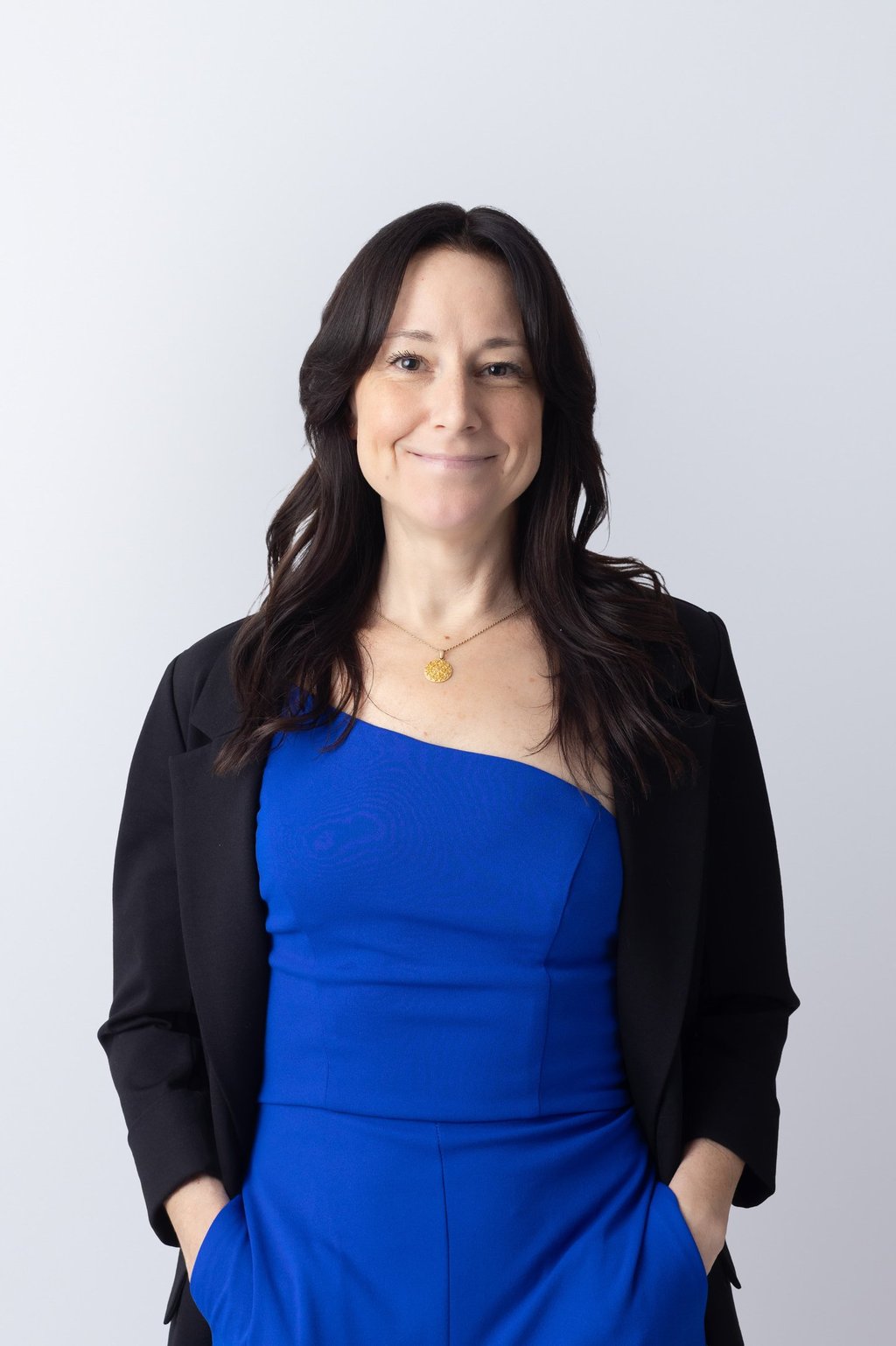 a woman wearing a blue outfit and black jacket