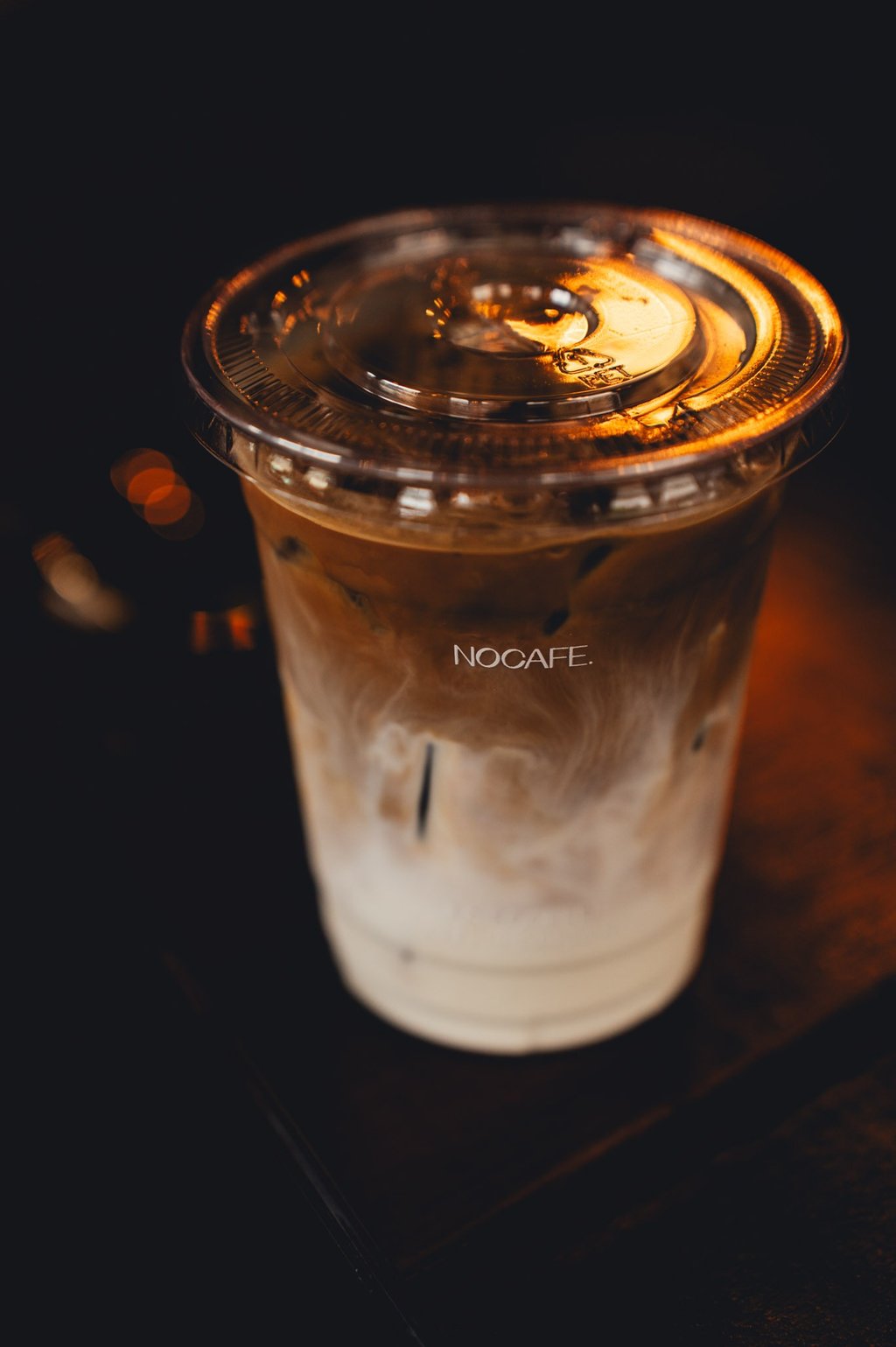 a cup of coffee with a candle on a table