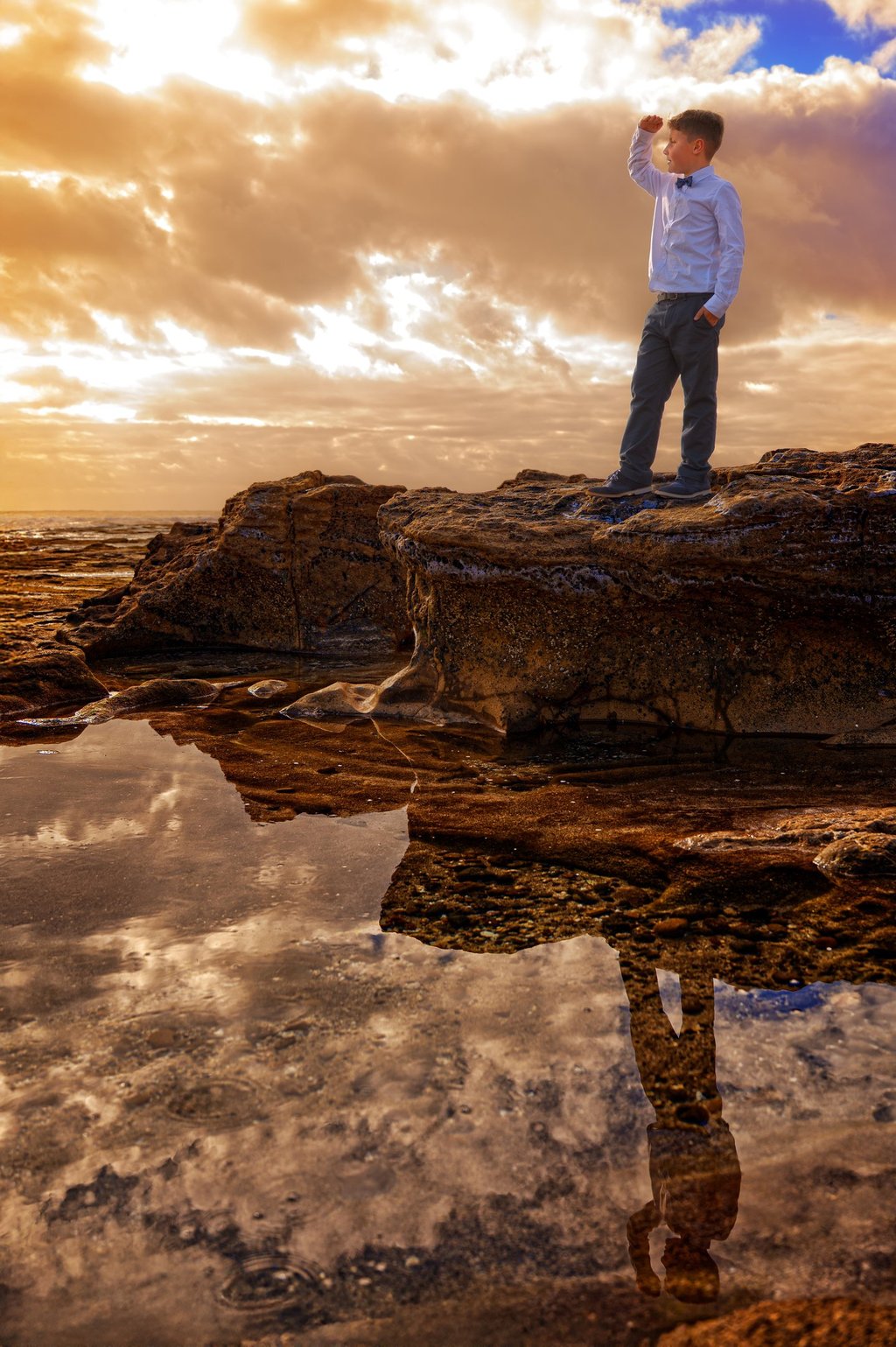 a man standing on a rock with a camera