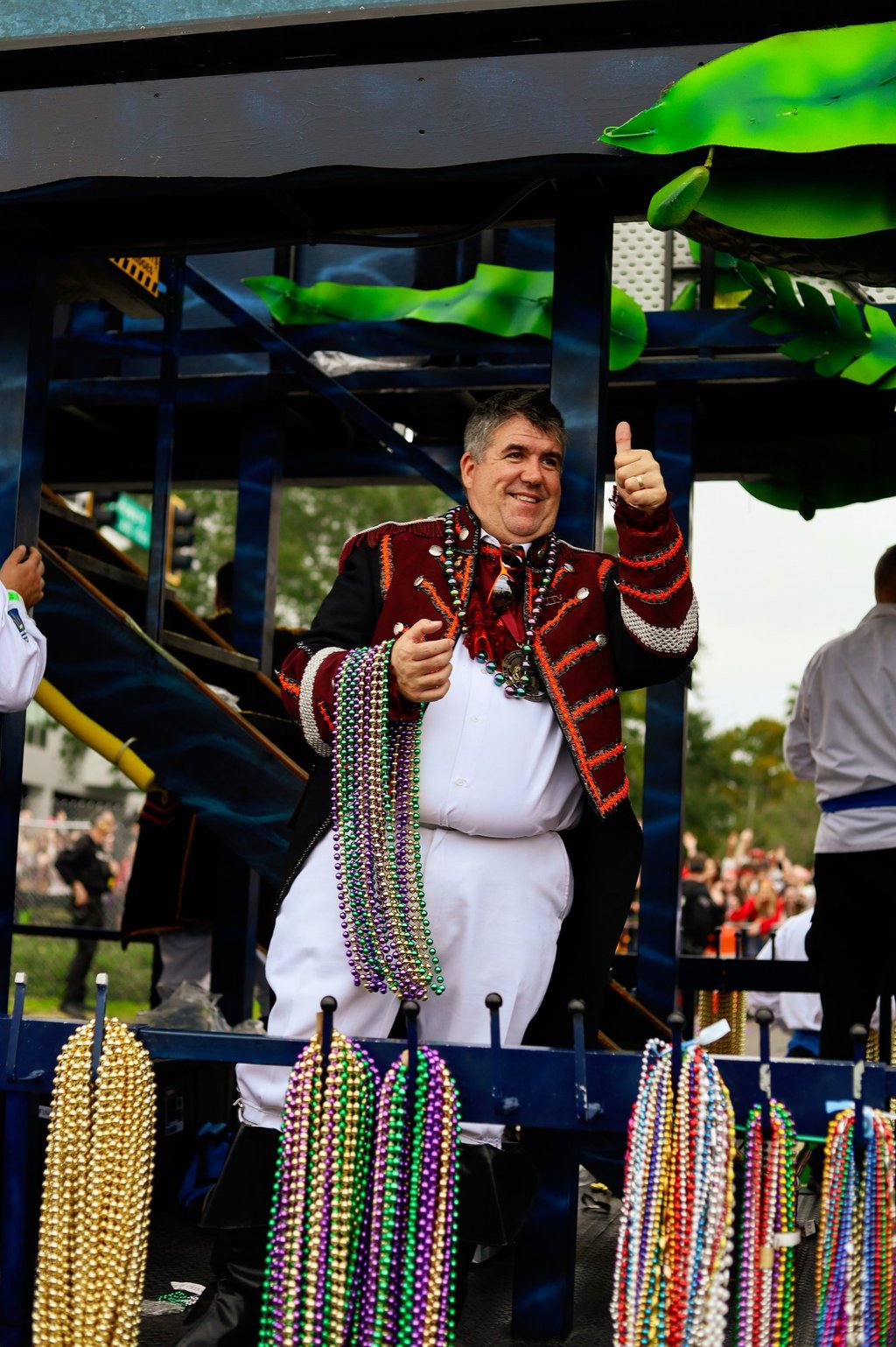 man dressed as pirate with armful of beads to throw