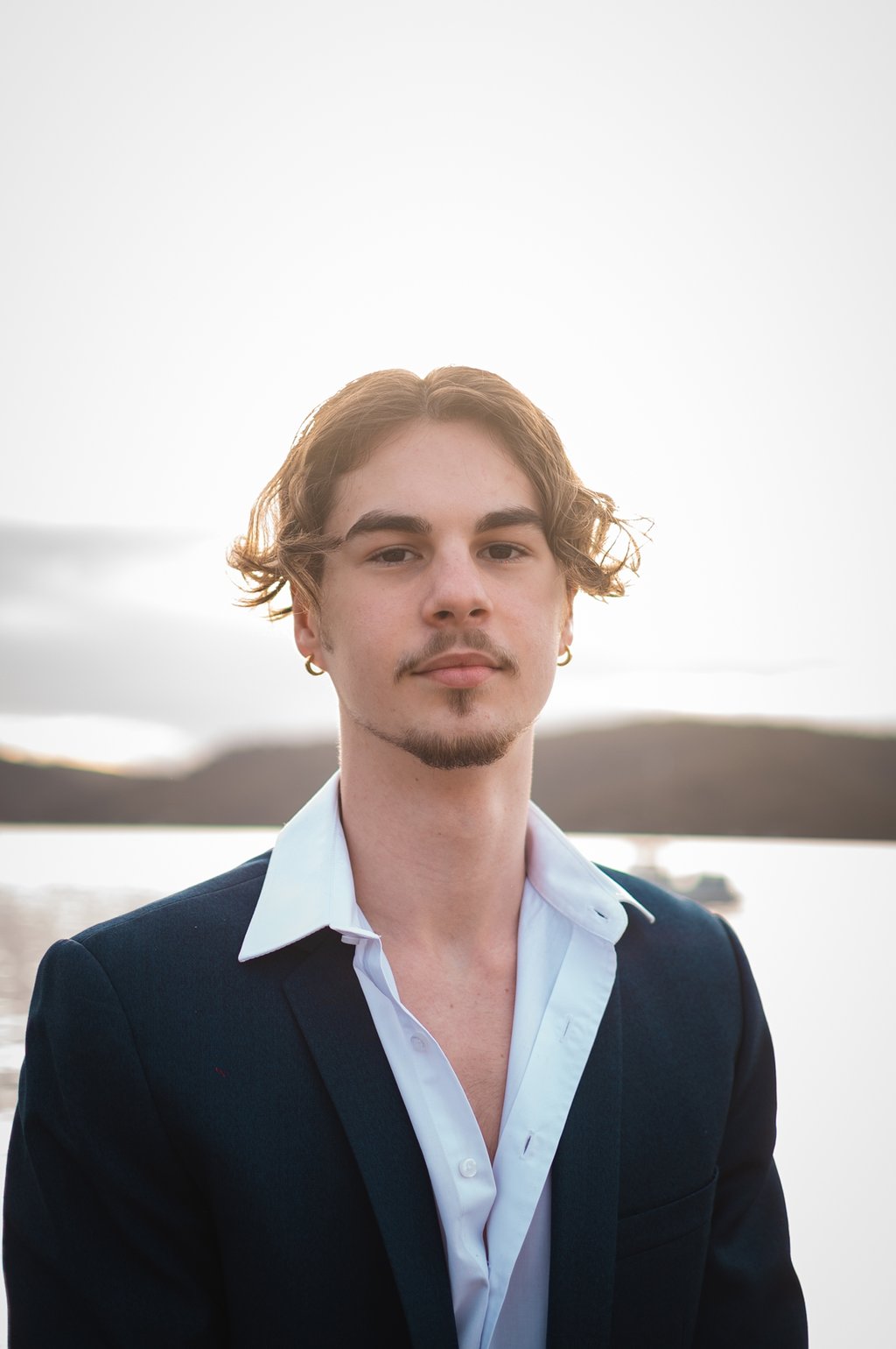 a man in a suit and white shirt
