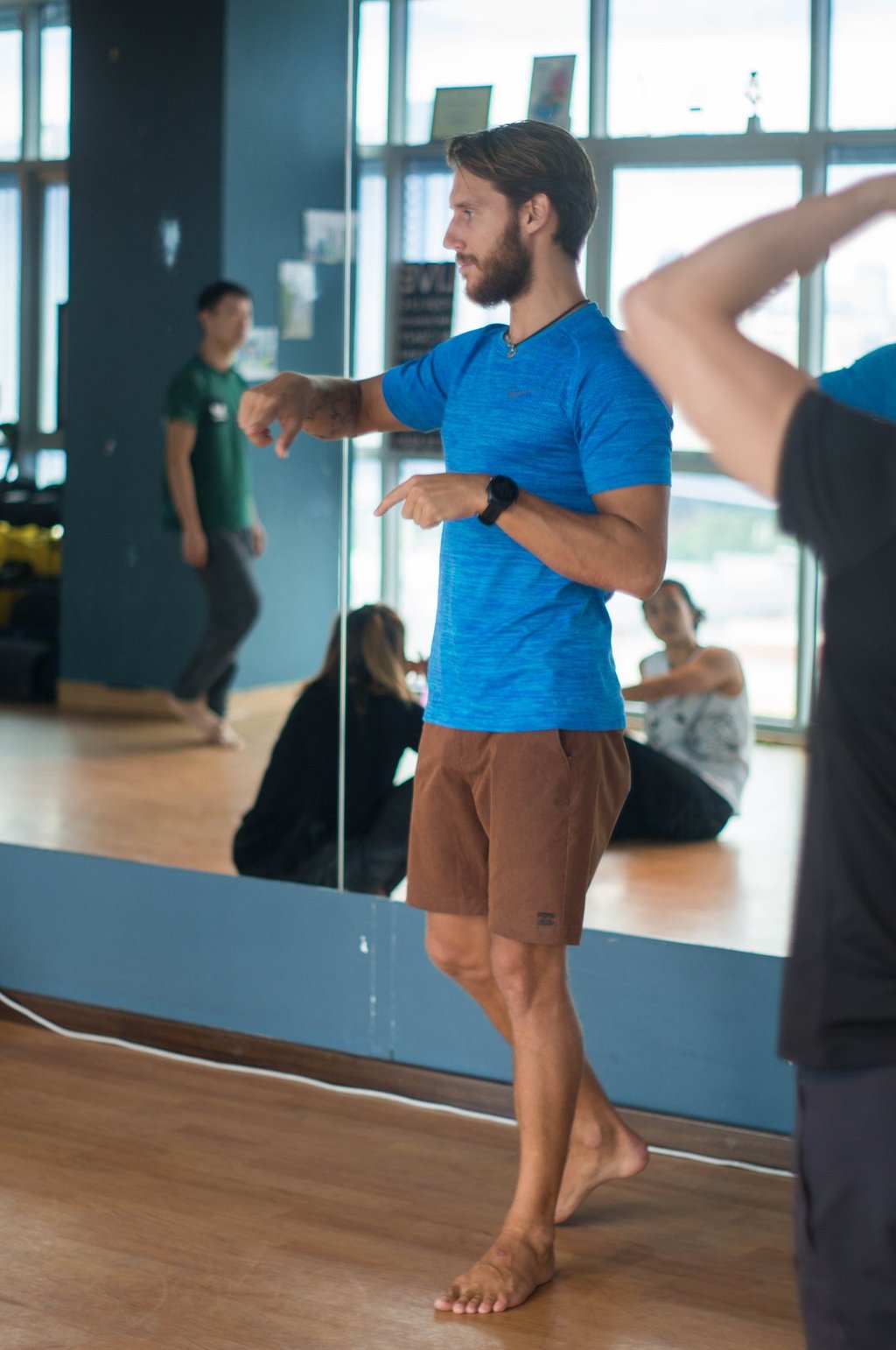 a man in a blue shirt is coaching movement