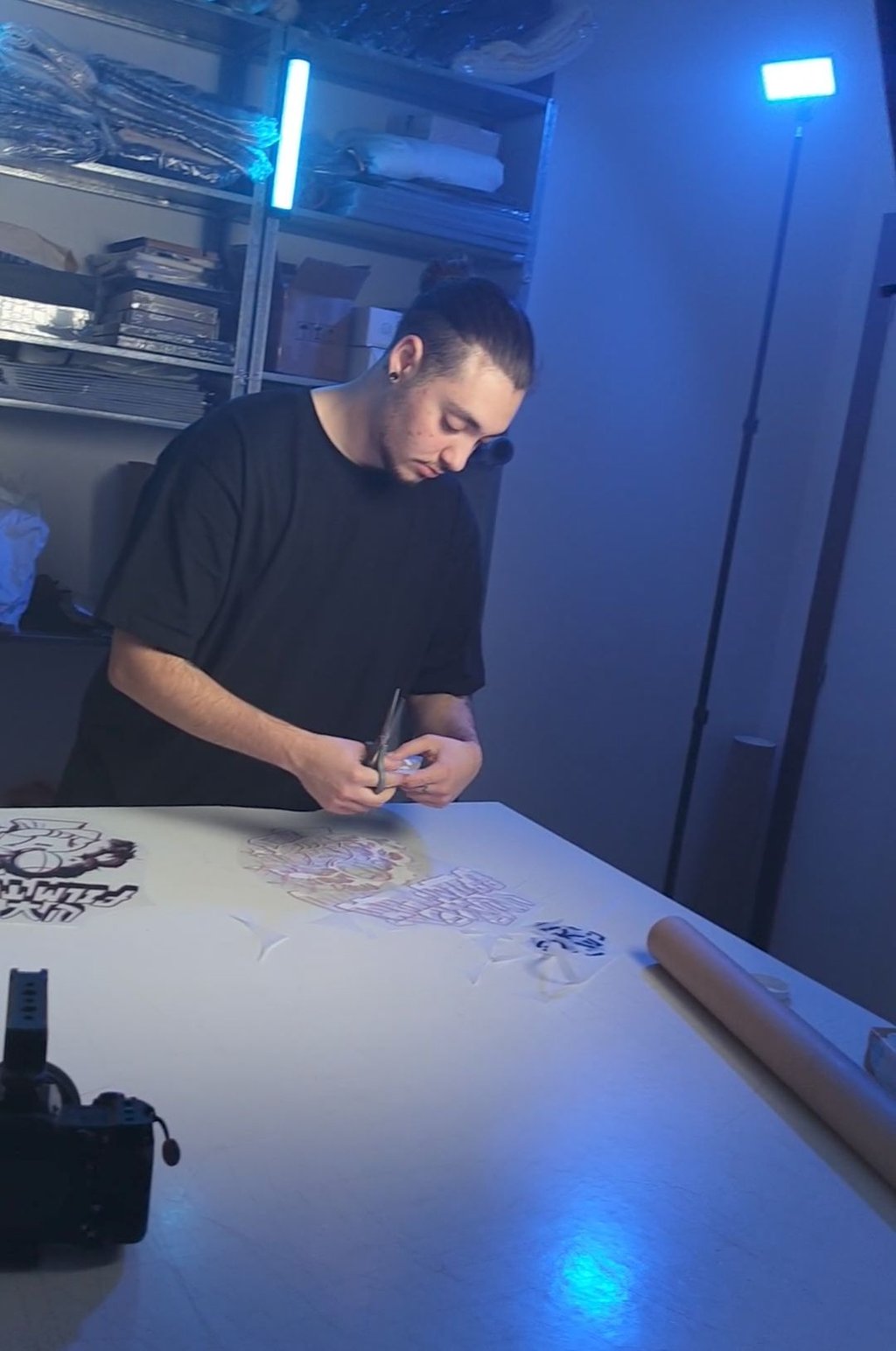 a man is cutting paper with a knife and scissors
