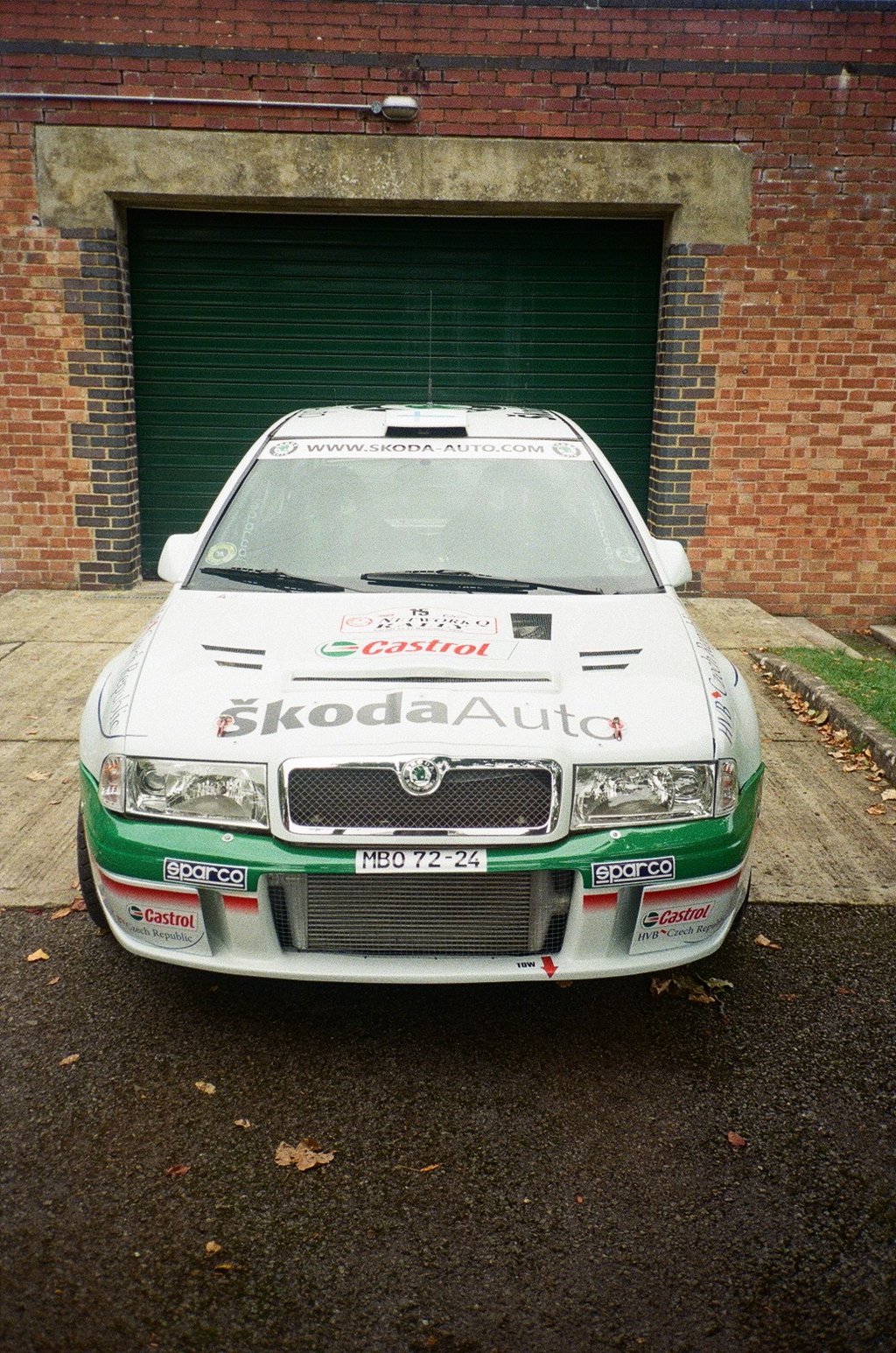a rally car parked in front of a garage