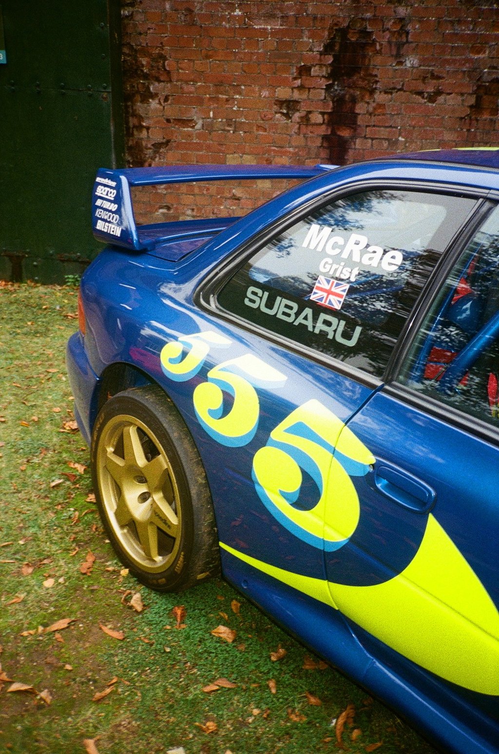 a blue and yellow Subaru Impreza rally car