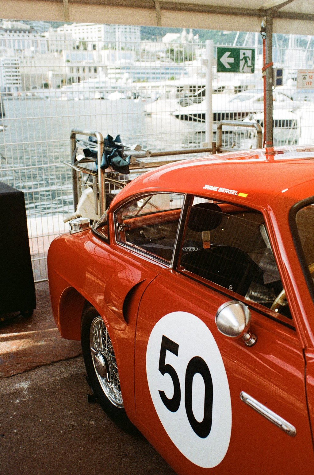 a red race car parked in the paddock