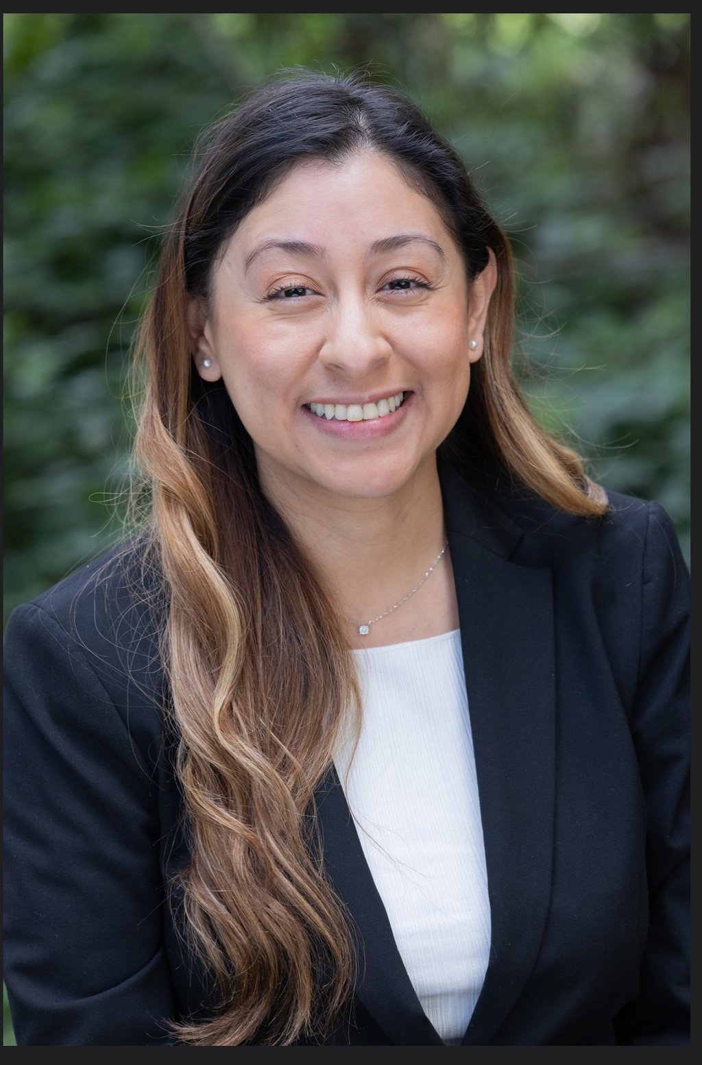 a woman in a black suit and white shirt