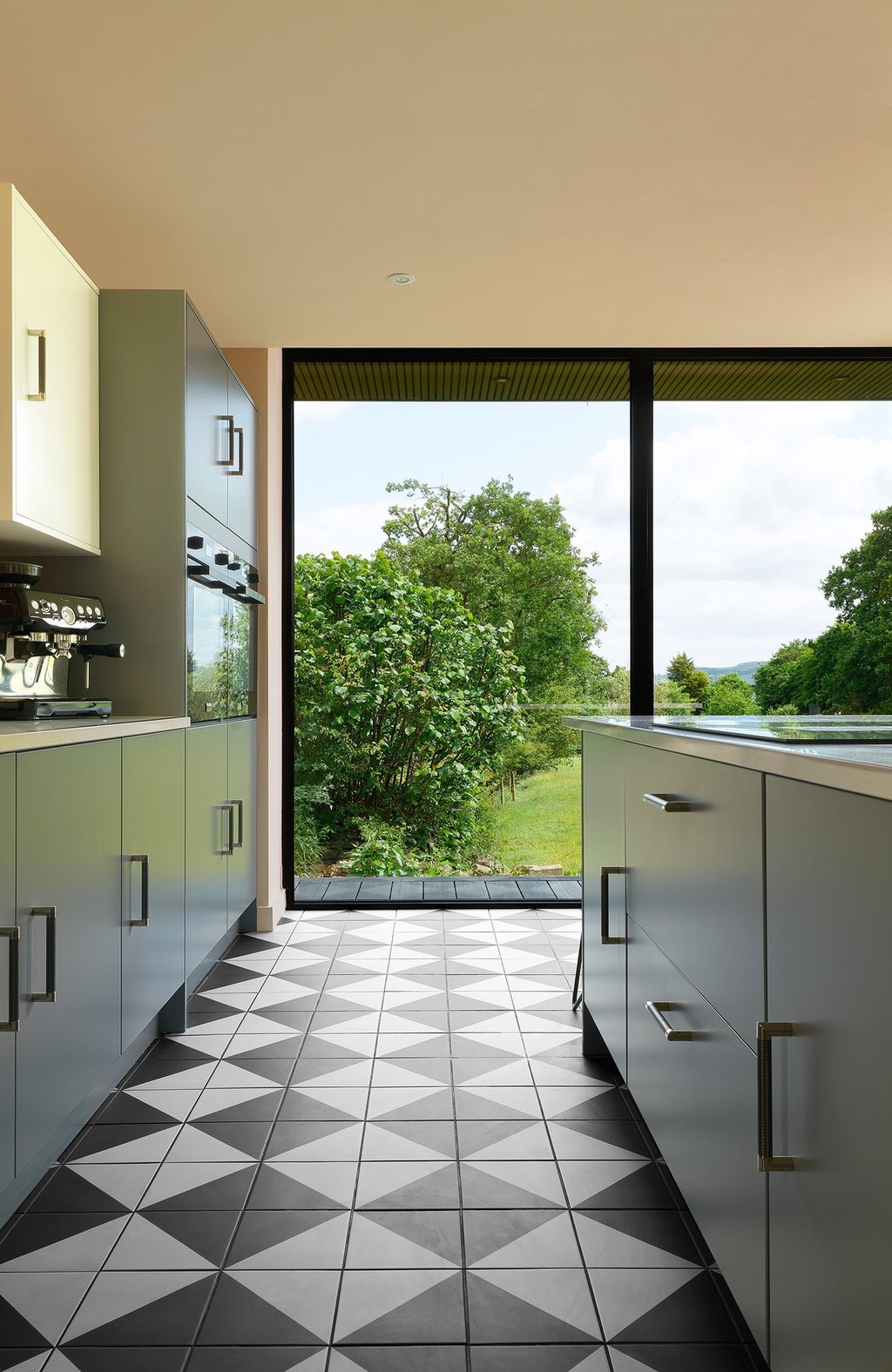 Black and white floor tiles laid in a diamond pattern with oak wood flooring