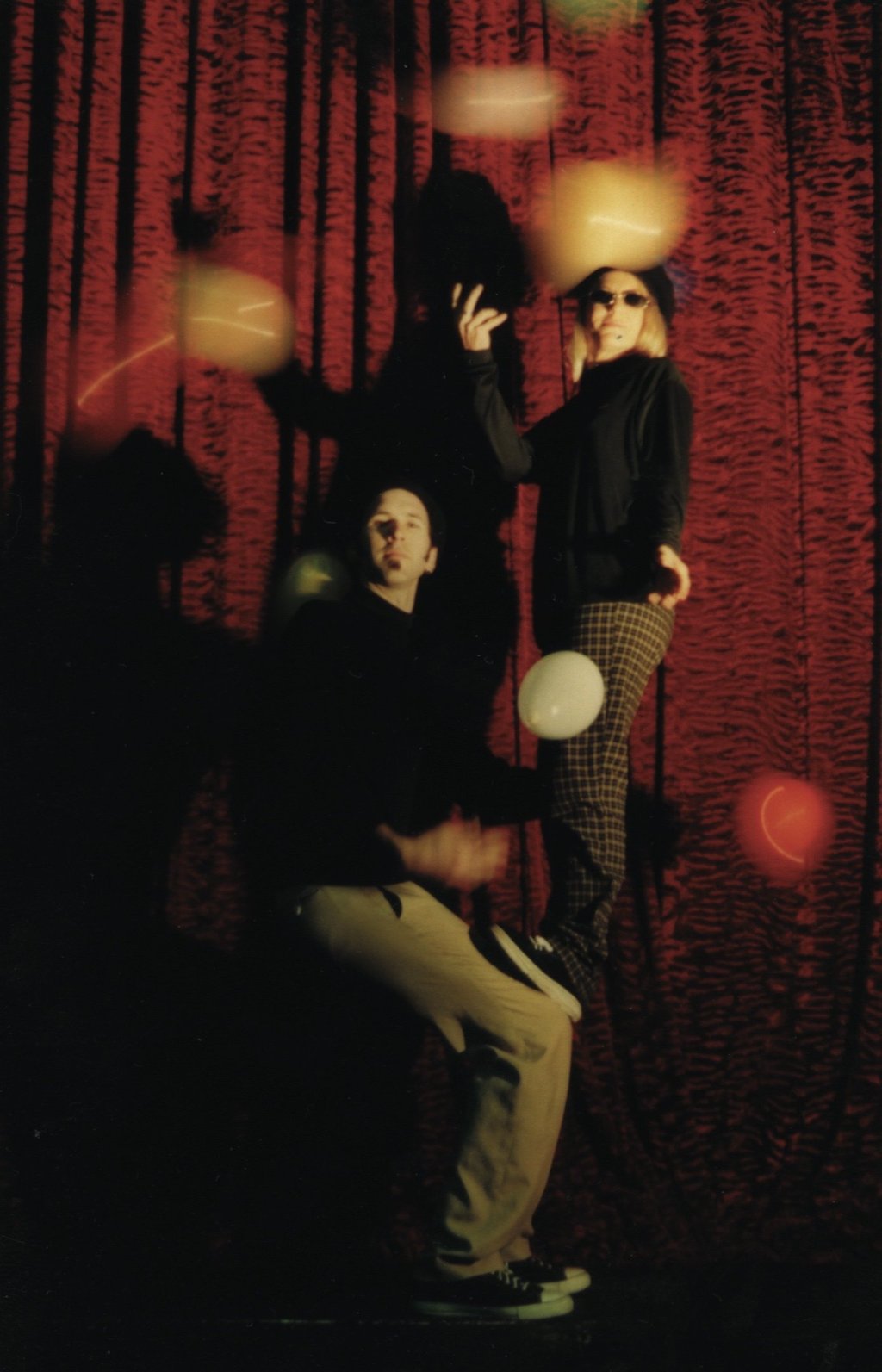 a man and woman beatnik doing an acrobatic balance