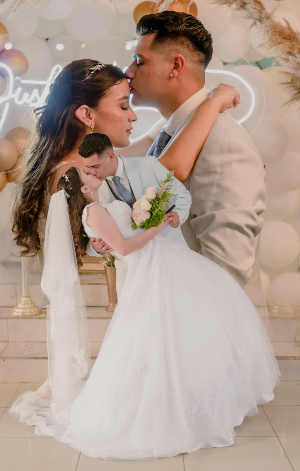 a bride and groom kissing in front of a neon sign