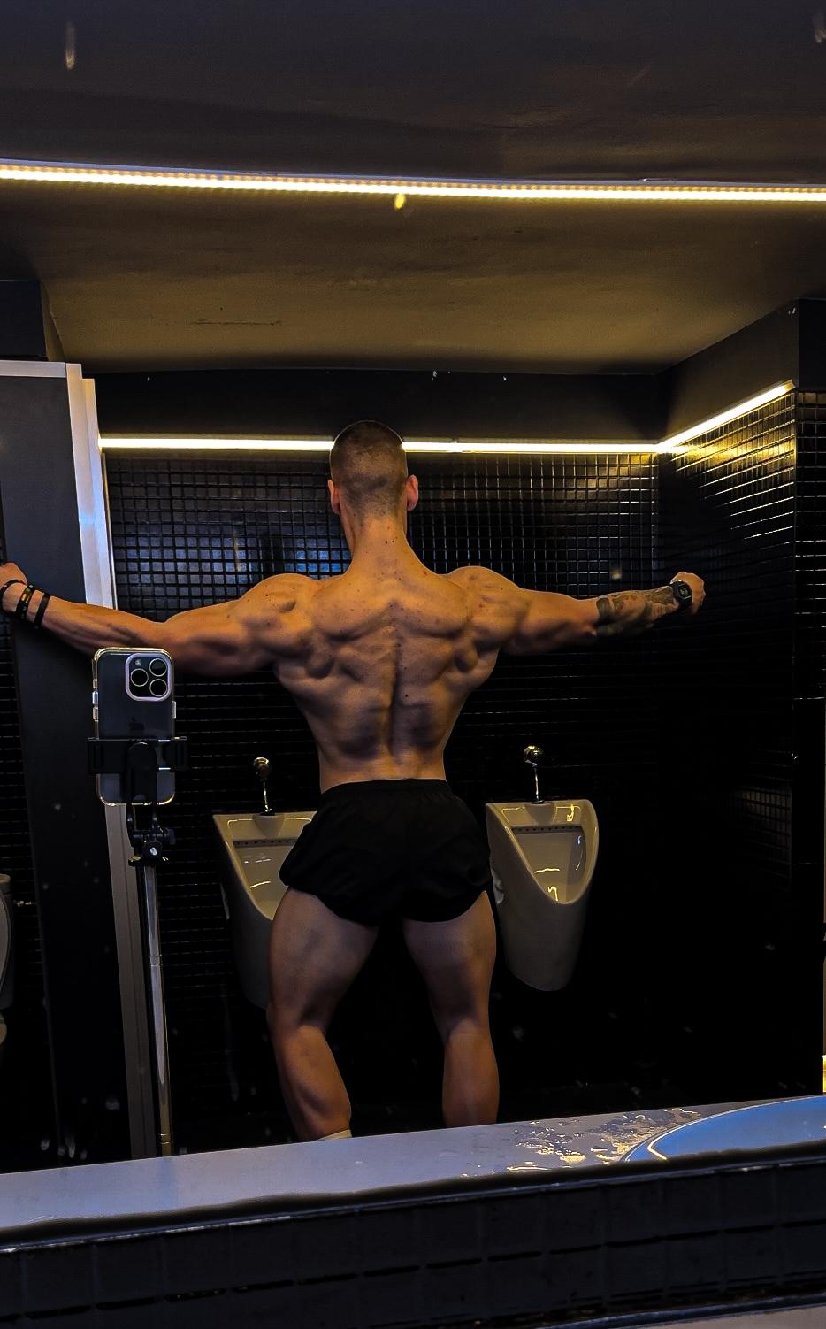 a man in a black underwear suit with a muscular body