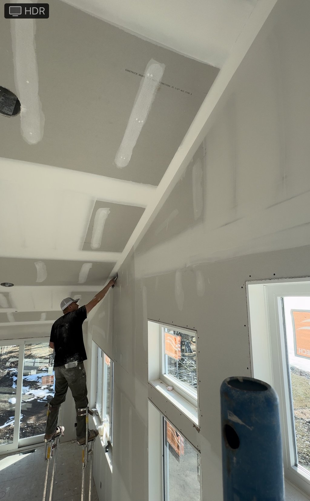 Cal Bakeberg, Owner of C&B Drywall, mudding a wall