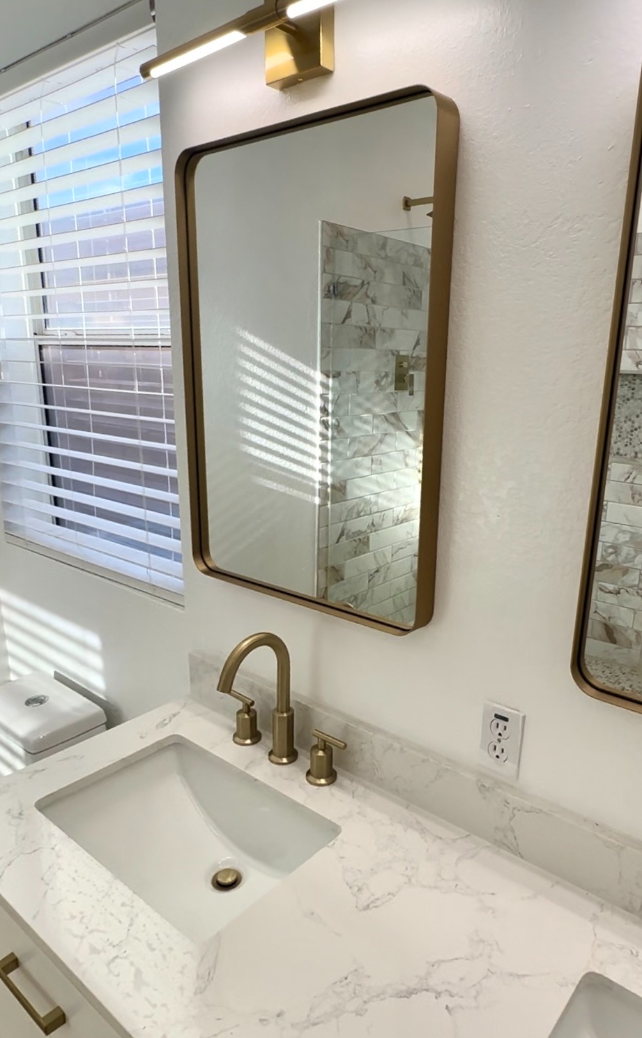 bathroom sink with gold faucet