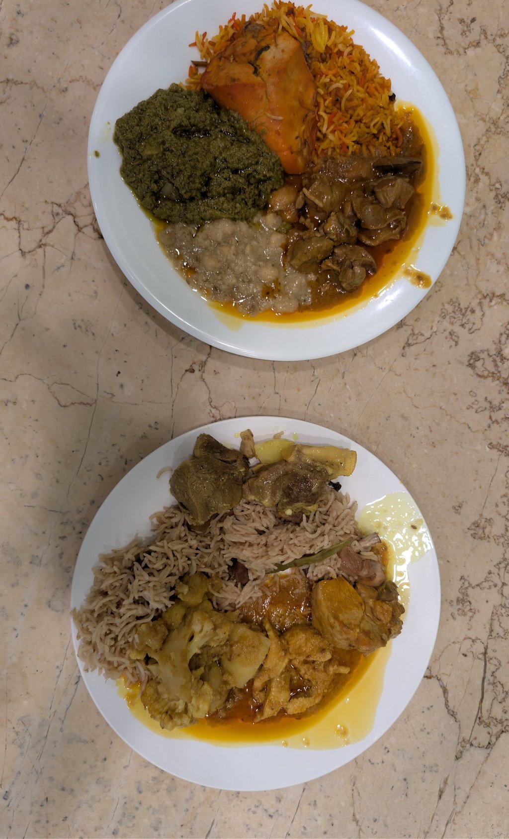 Authentic Pakistani dinner plates with basmati rice, lamb curry, saag, and spicy chicken biryani.