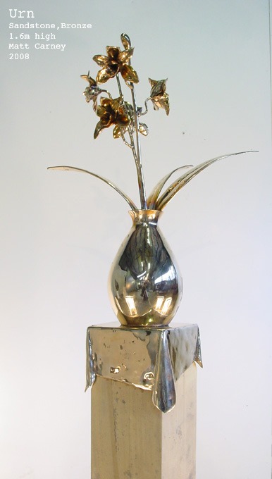 a sculpture of a vase with flowers
