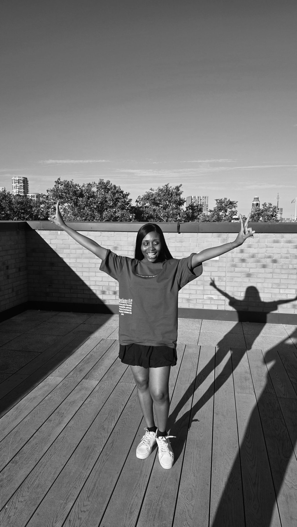 a woman standing on a deck with her arms up