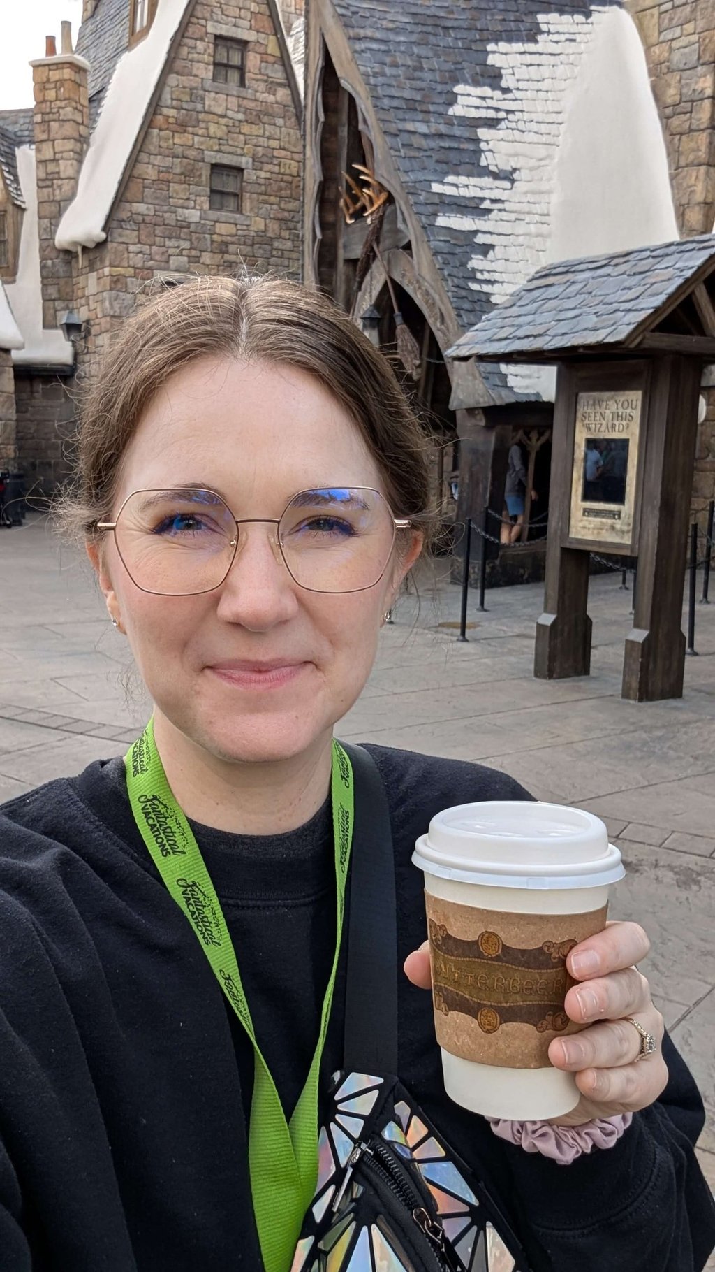 Katie Matzenbacher, Travel Advisor, holding a hot butterbeer in Hogsmeade at Universal Orlando