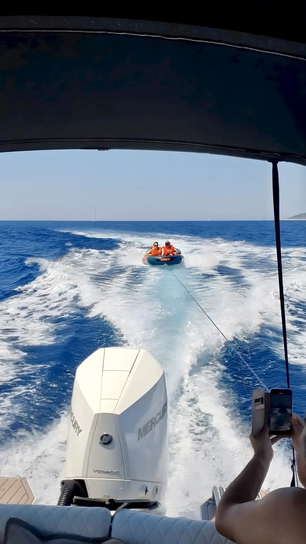Guests enjoying JOBE towel tube as a part of Fun Pack on private boat tour from Split