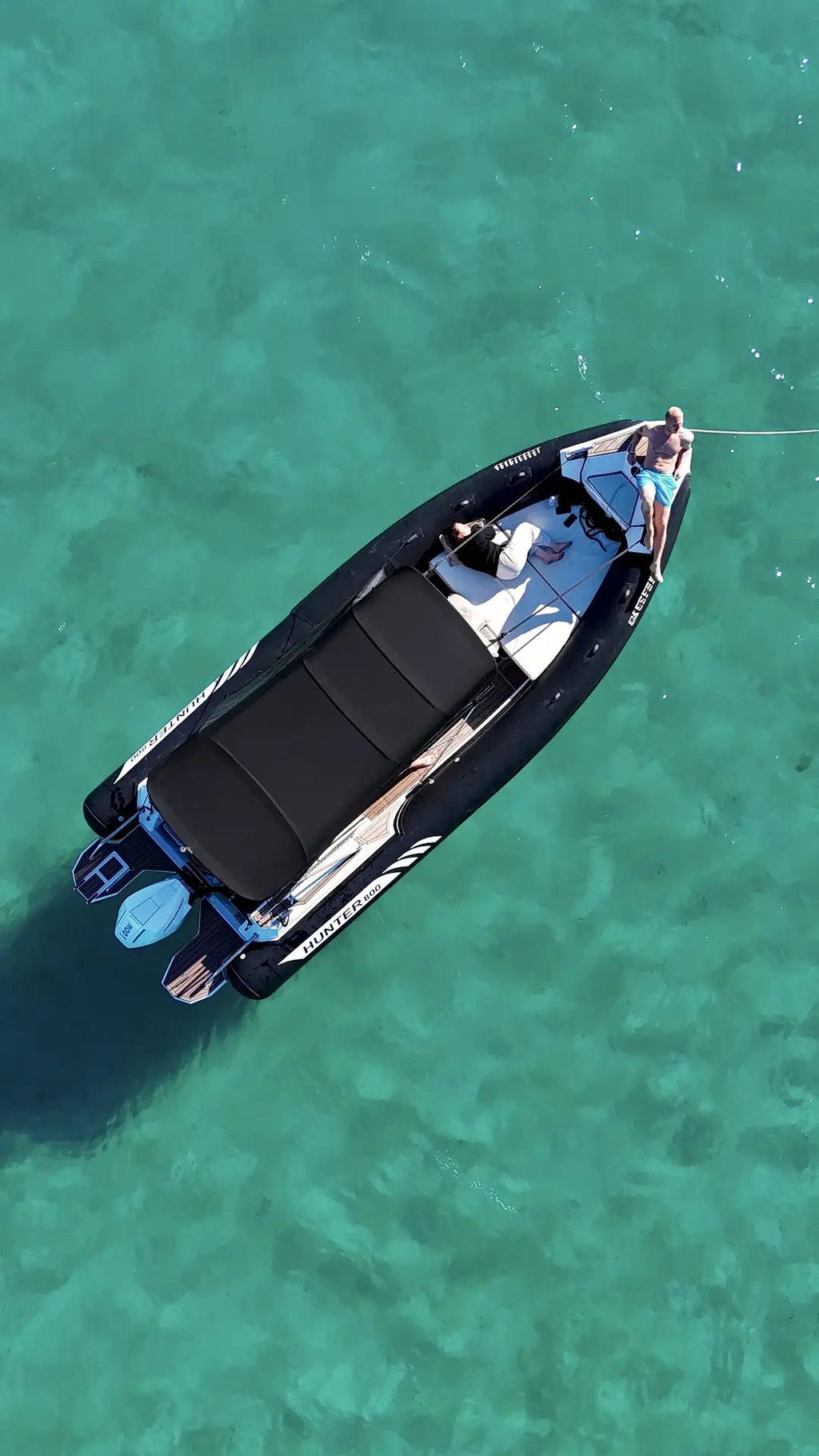 Aerial of Hunter Pro 800 RIB speedboat anchored in Adriatic water with guests on bow sundeck during private tour from Split.