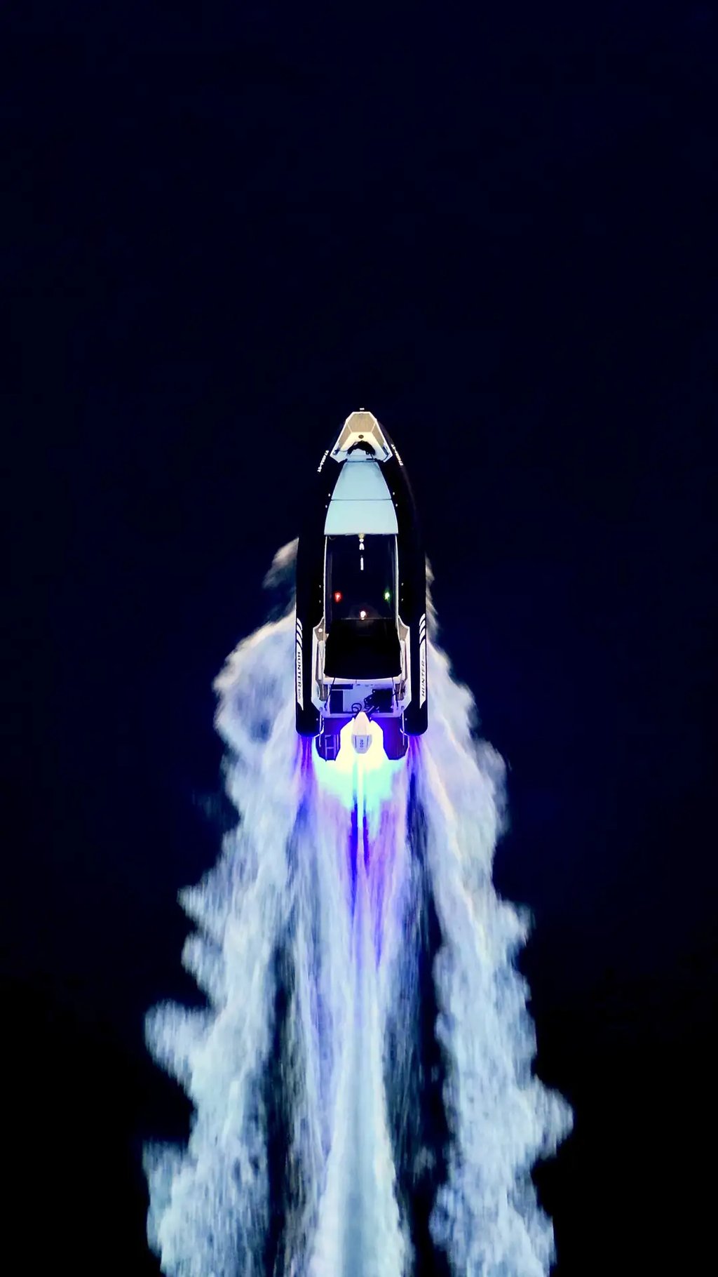 Hunter Pro 800 RIB speedboat cruising at night with underwater lights and ambient deck lighting captured from above