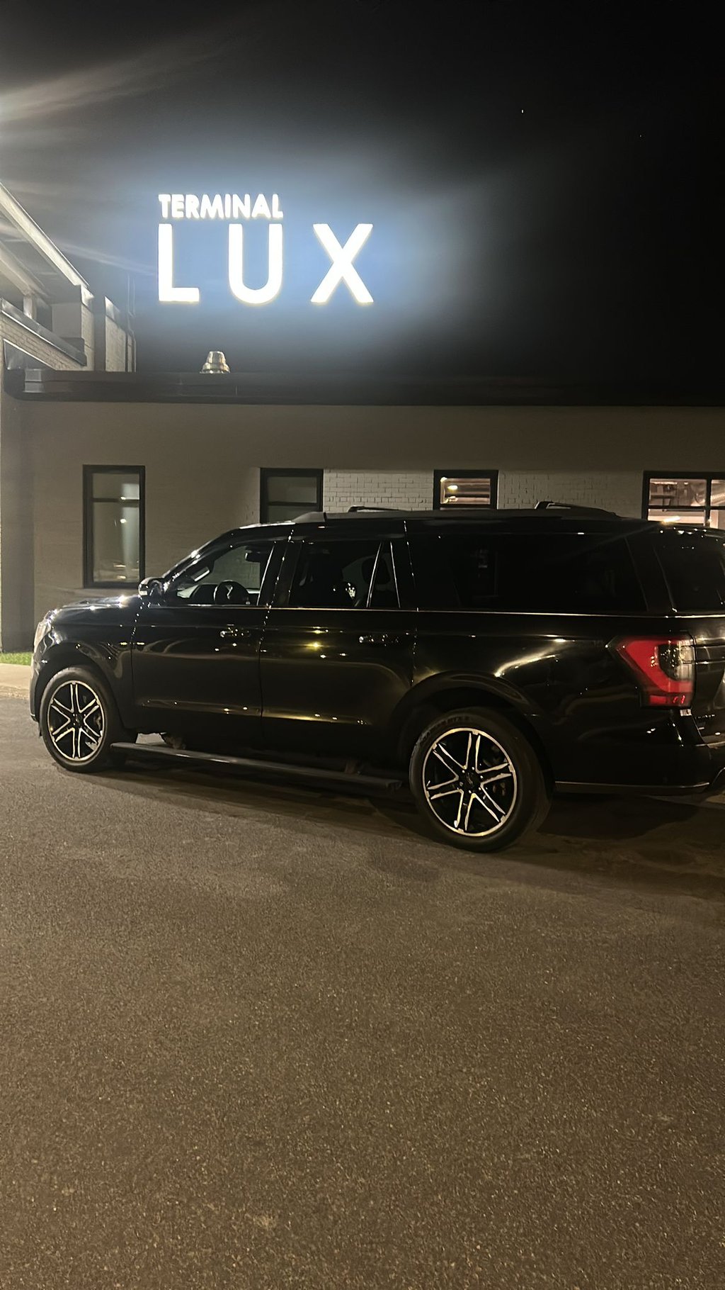 Emilios Limo black suv parked in front of a building