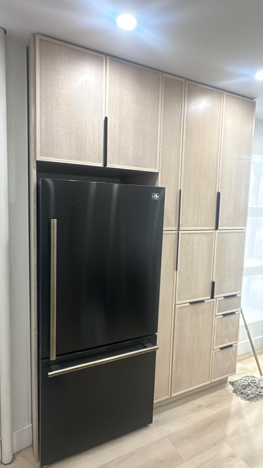 a refrigerator with a black refrigerator and a black refrigerator