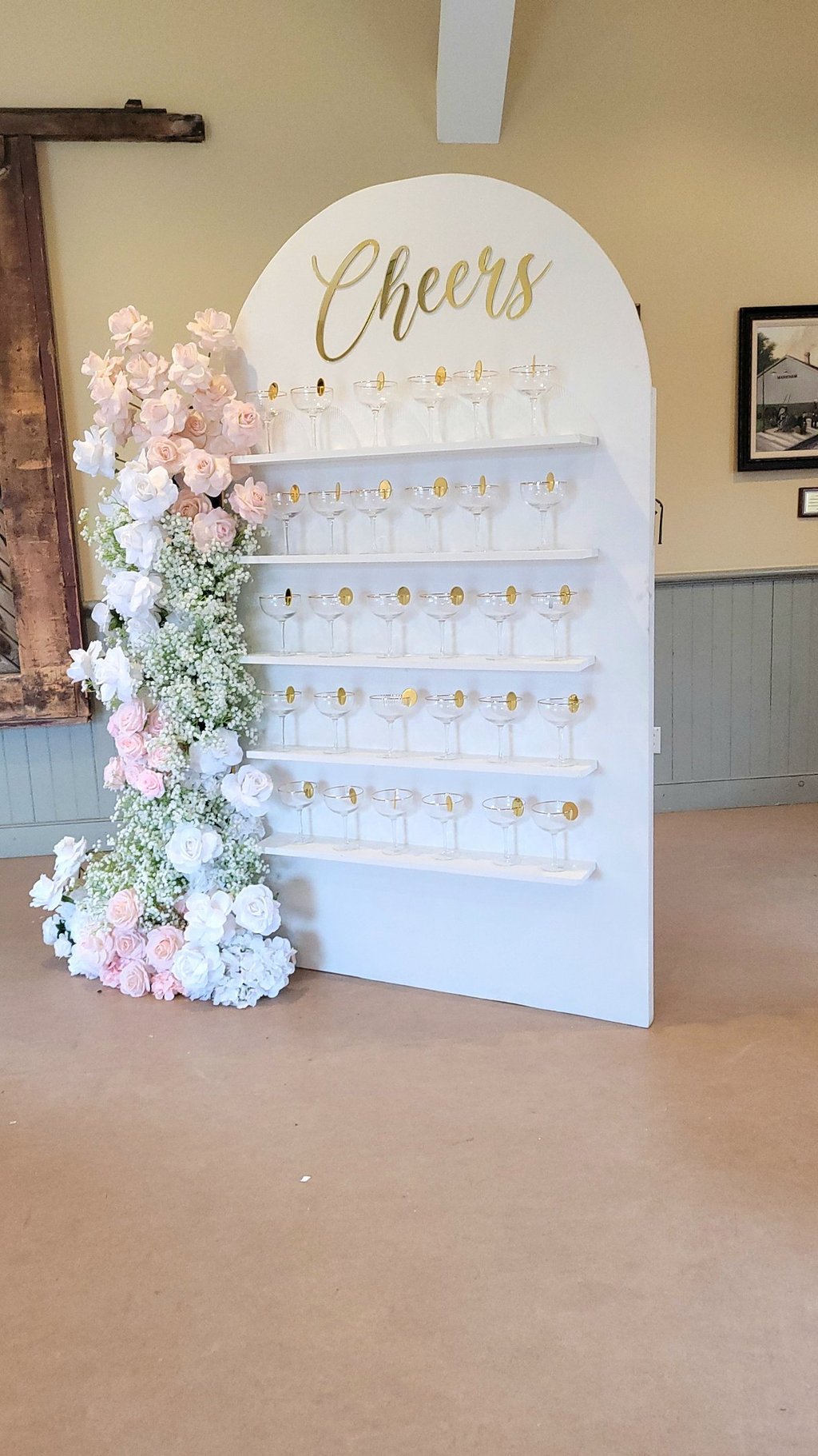 White champagne with a pink and white floral arrangement and champagne flutes