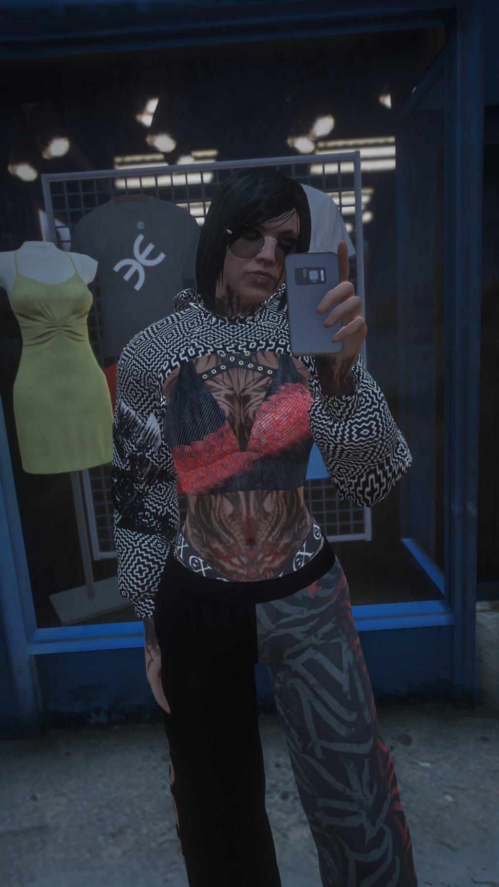 a woman in a top hat and sunglasses taking a selfie