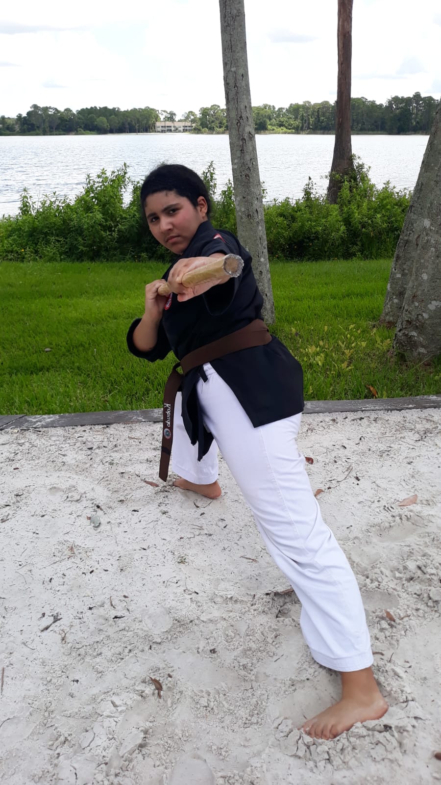Kobudo practice with traditional Okinawan weapons in martial arts dojo.