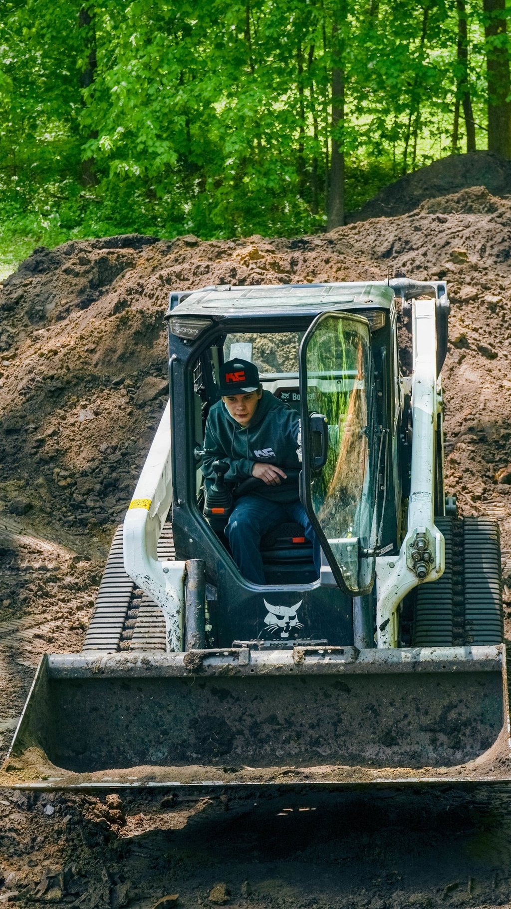 Kruse Contracting employee operating a bobcat skid steer