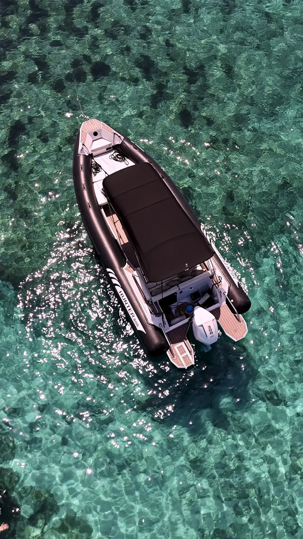 Premium black Hunter Pro 800 RIB drone view in turquoise waters of Blue Lagoon during a private boat tour from Split.