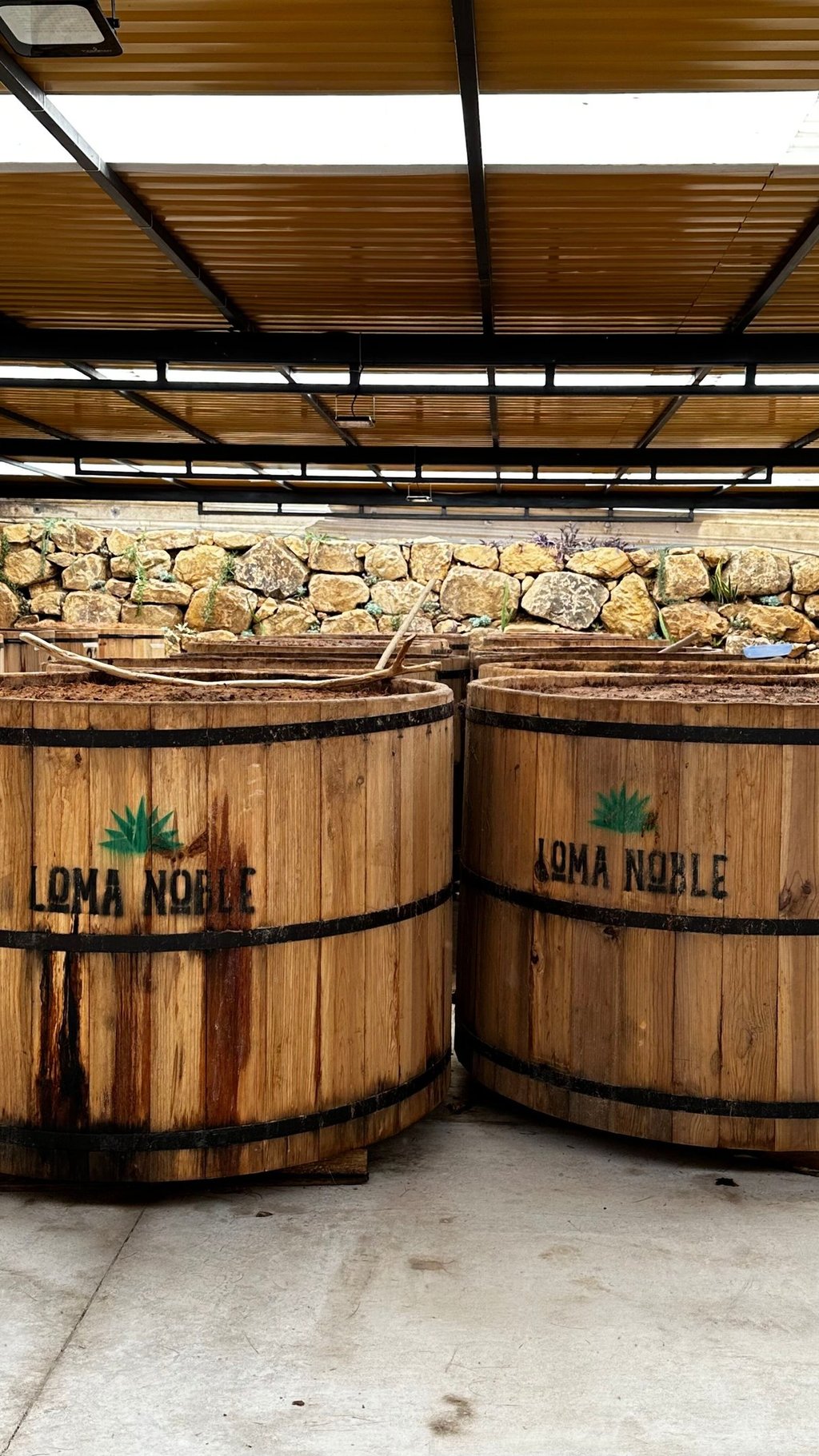 two wooden barrels with a wooden barrel of wine