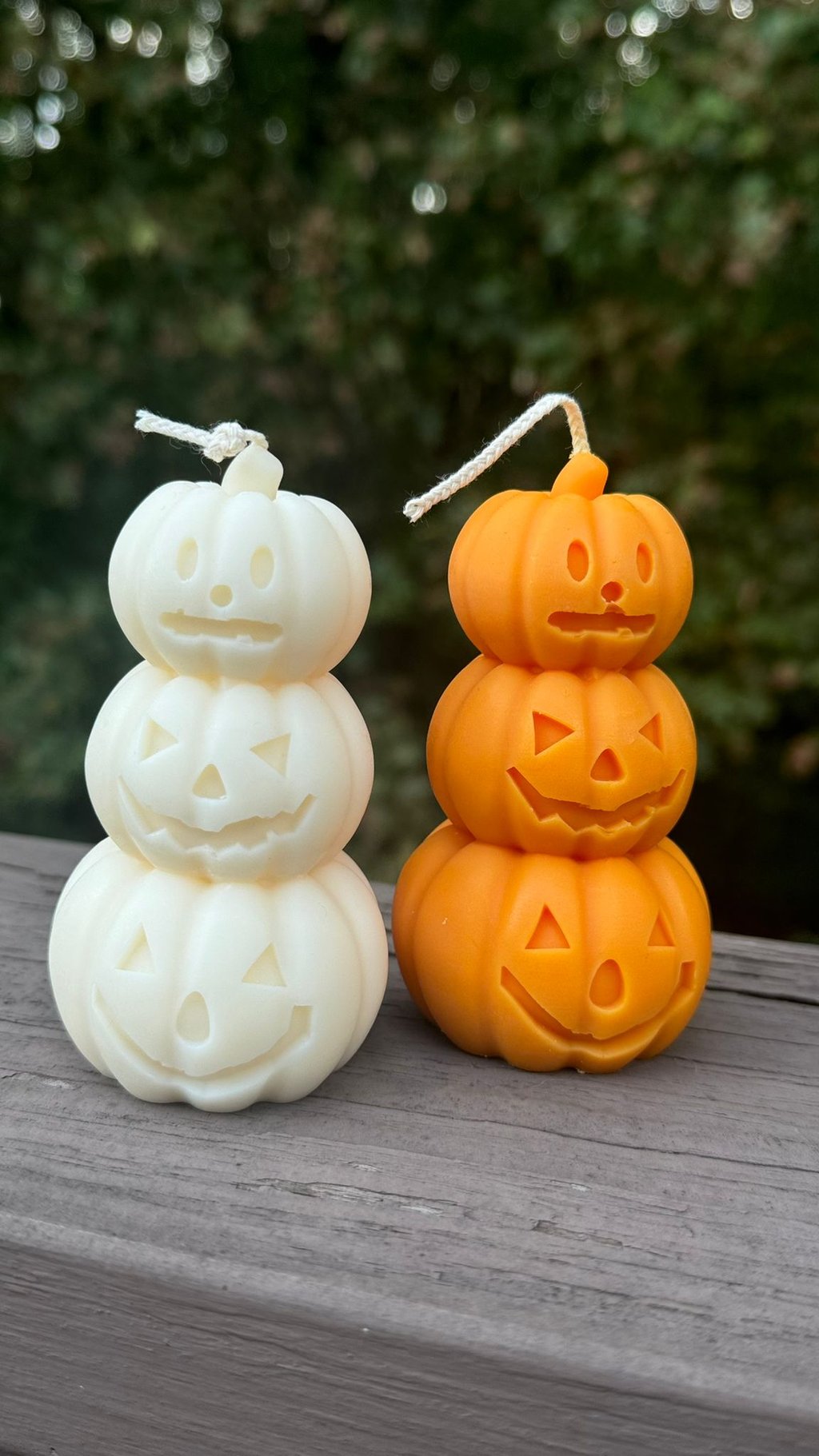Two pumpkin candles outdoors