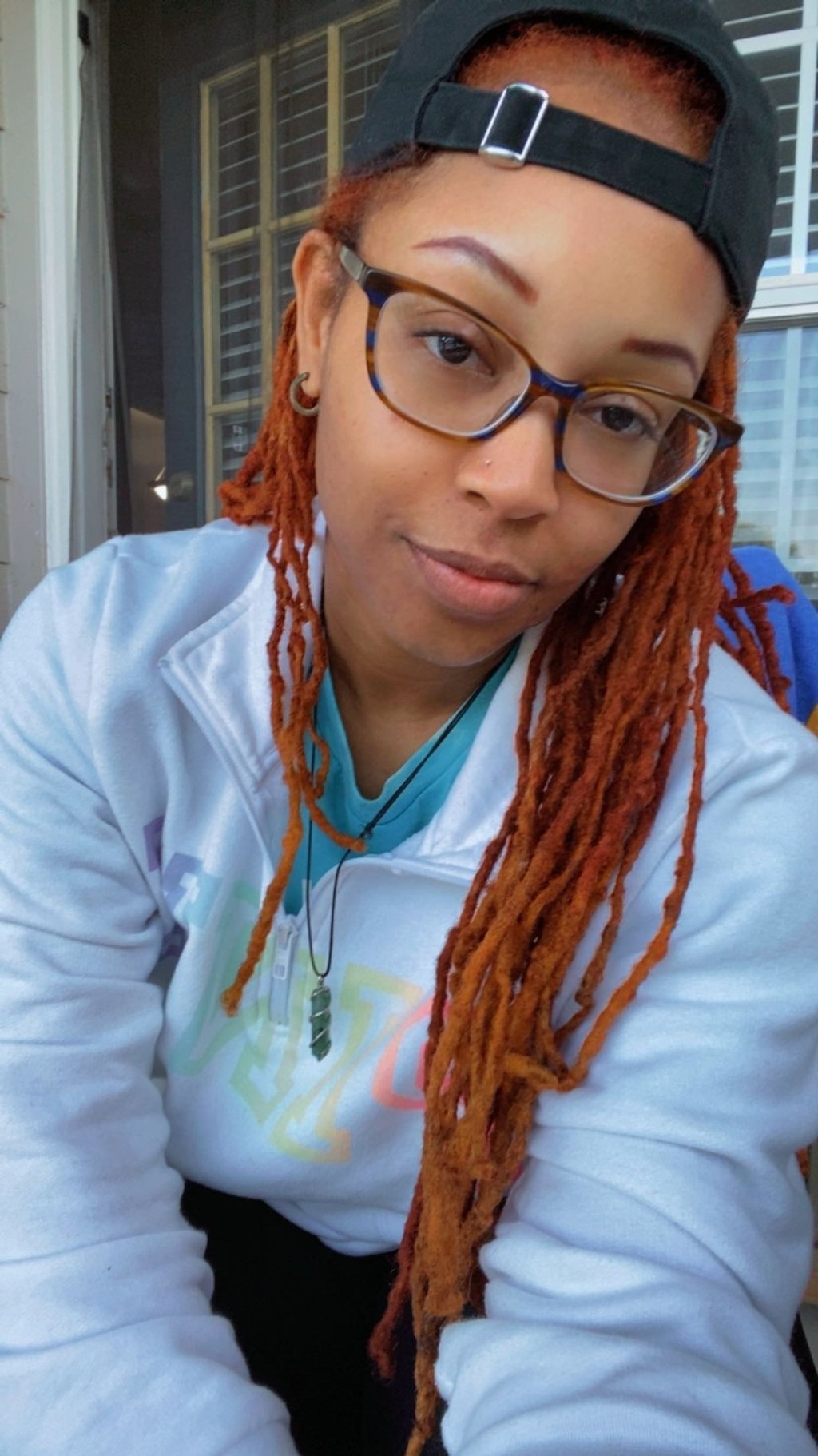 A woman with glasses smiling