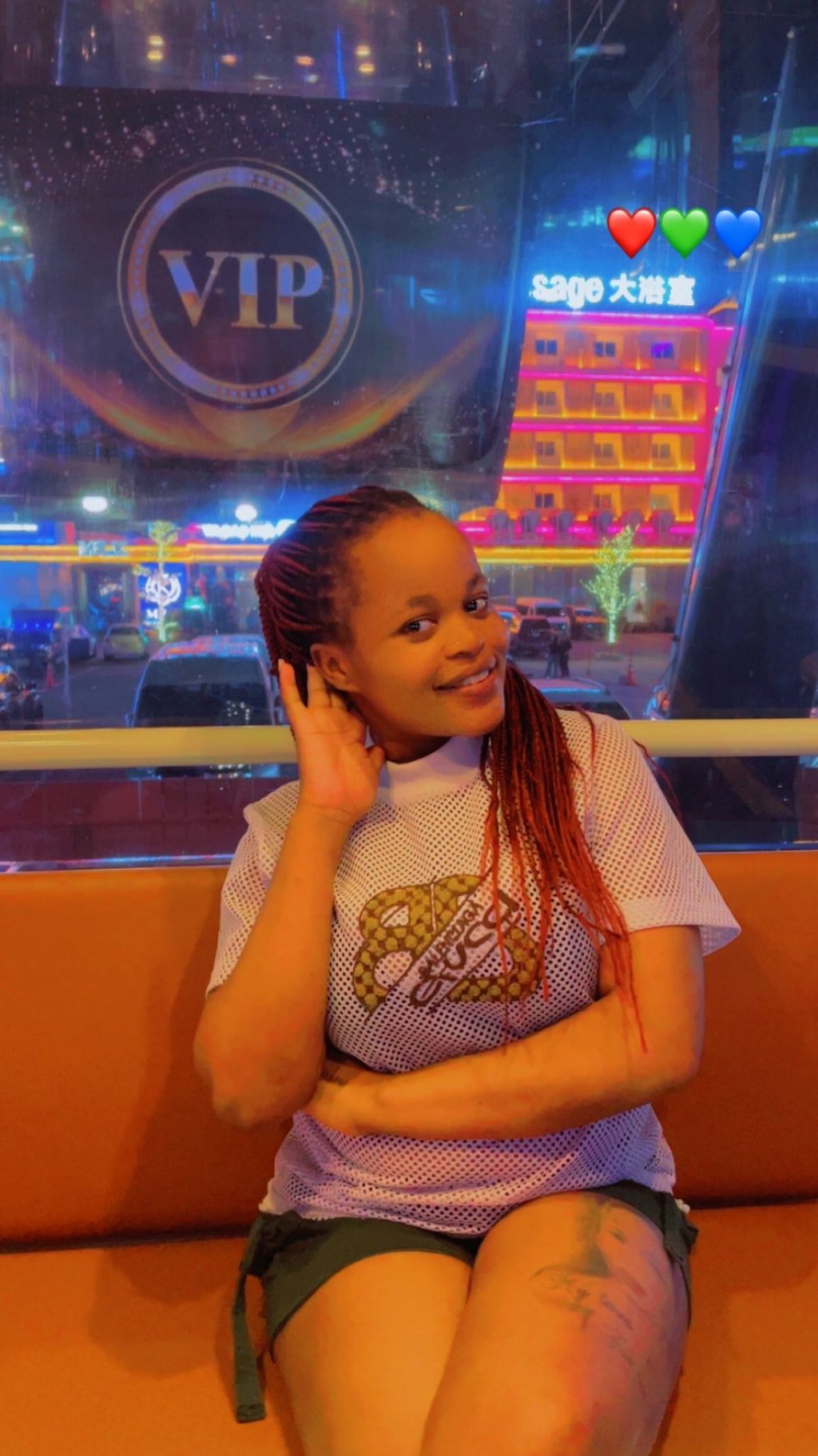 Experienced home massage therapist in Pattaya with a friendly and welcoming appearance, photographed in a night market