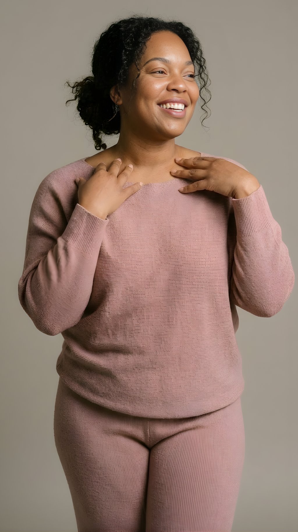 Smiling woman wearing a dusty rose long-sleeve knit sweater and matching pants lounge set.