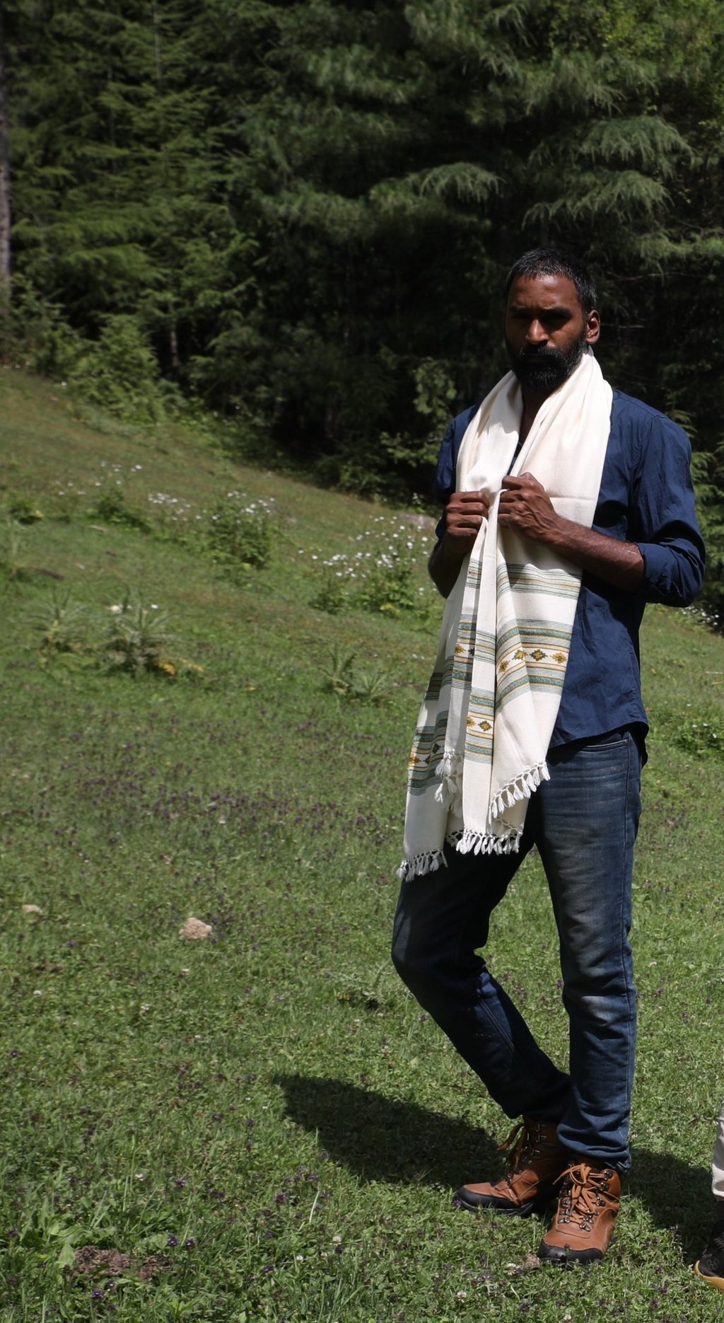 a man  standing in the grass with Vasanth shawl
