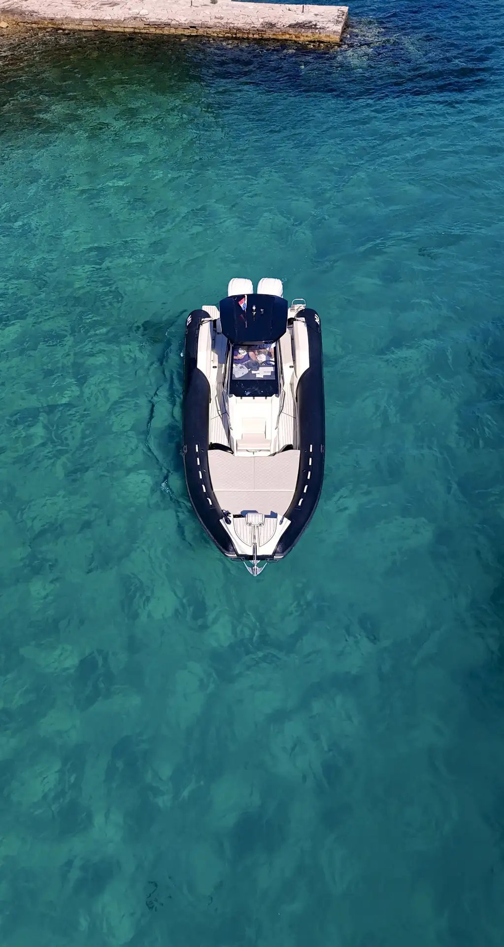 Aerial front view of Nuova Jolly Prince 30 Exclusive floating in turquoise water near Solta.